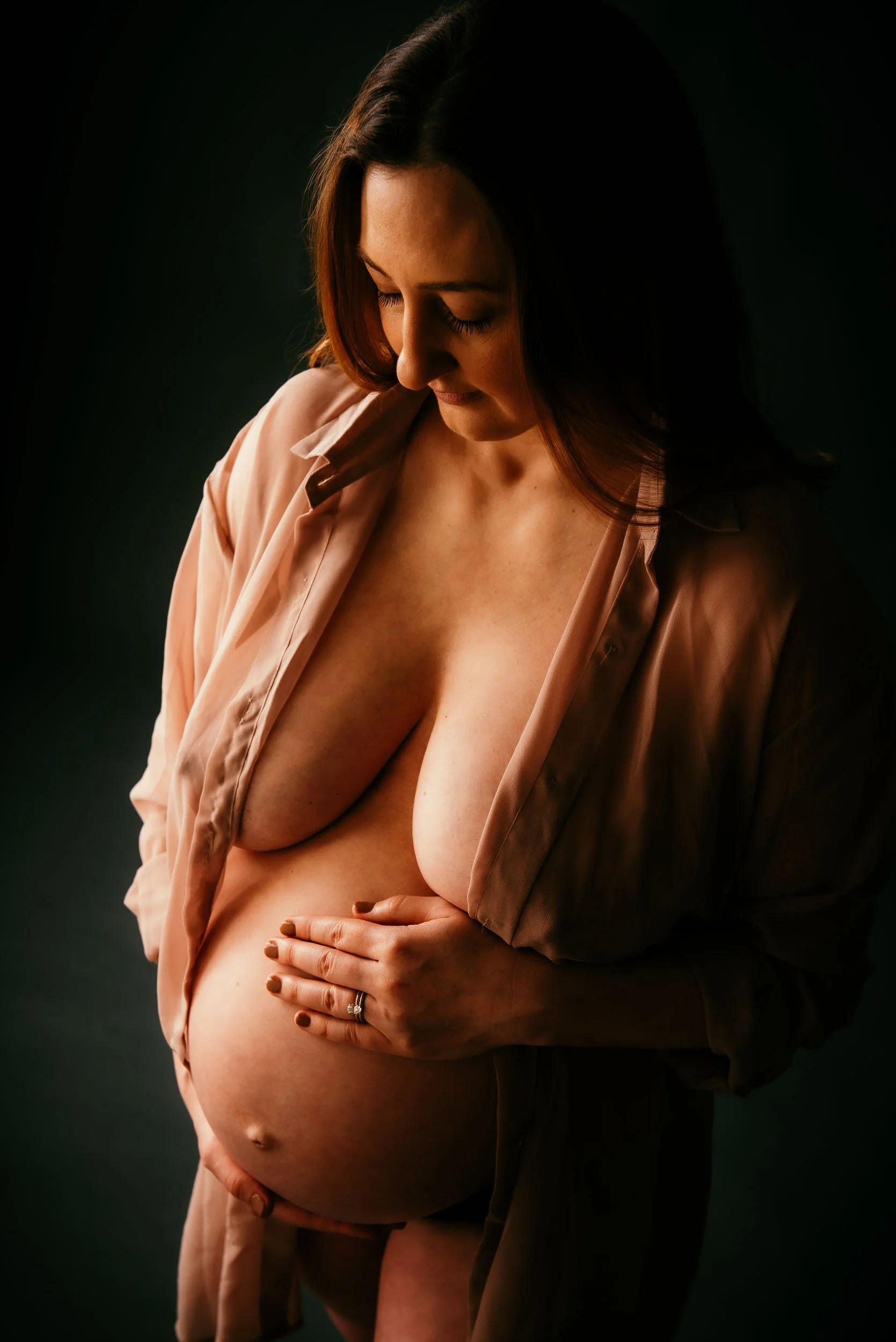Maternity Photoshoot of woman holding belly