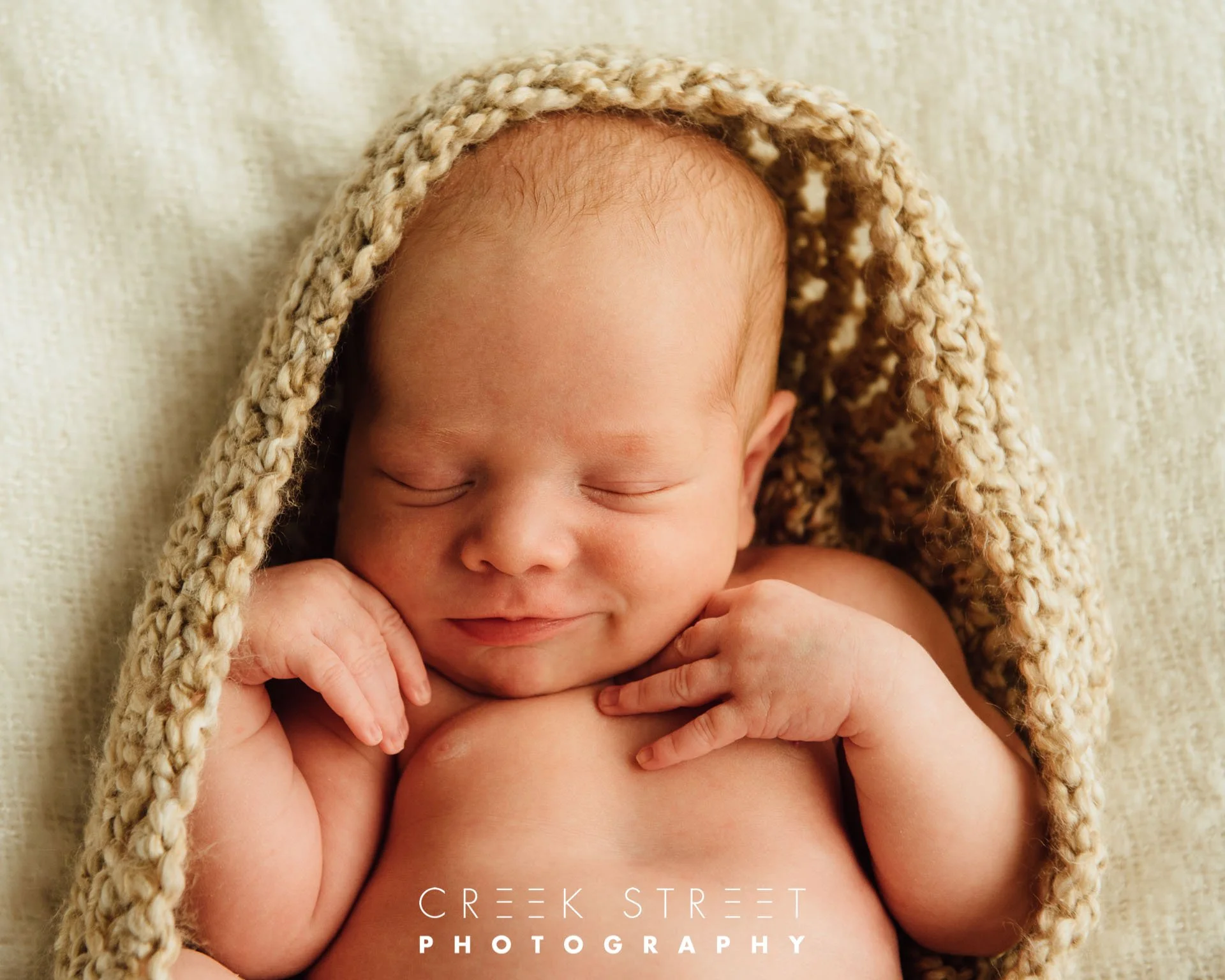smiling newborn studio photography.jpg