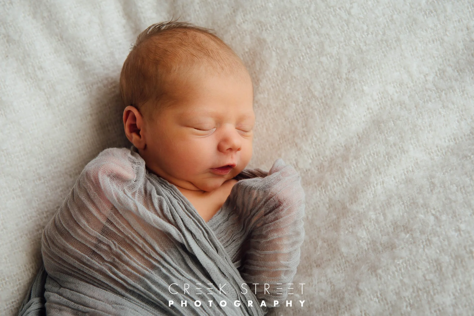 newborn in muslin wrap.jpg