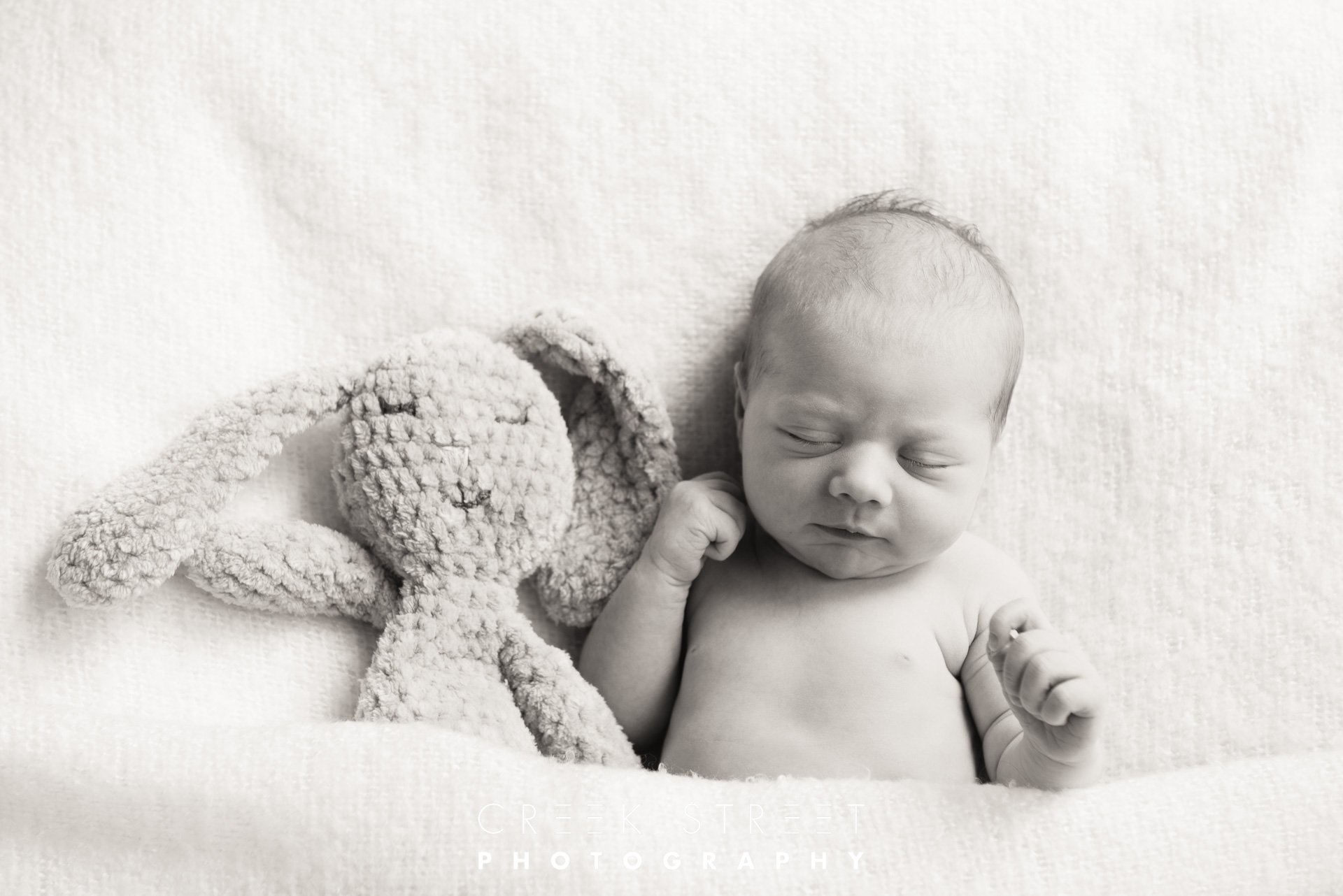 newborn with soft toy.jpg