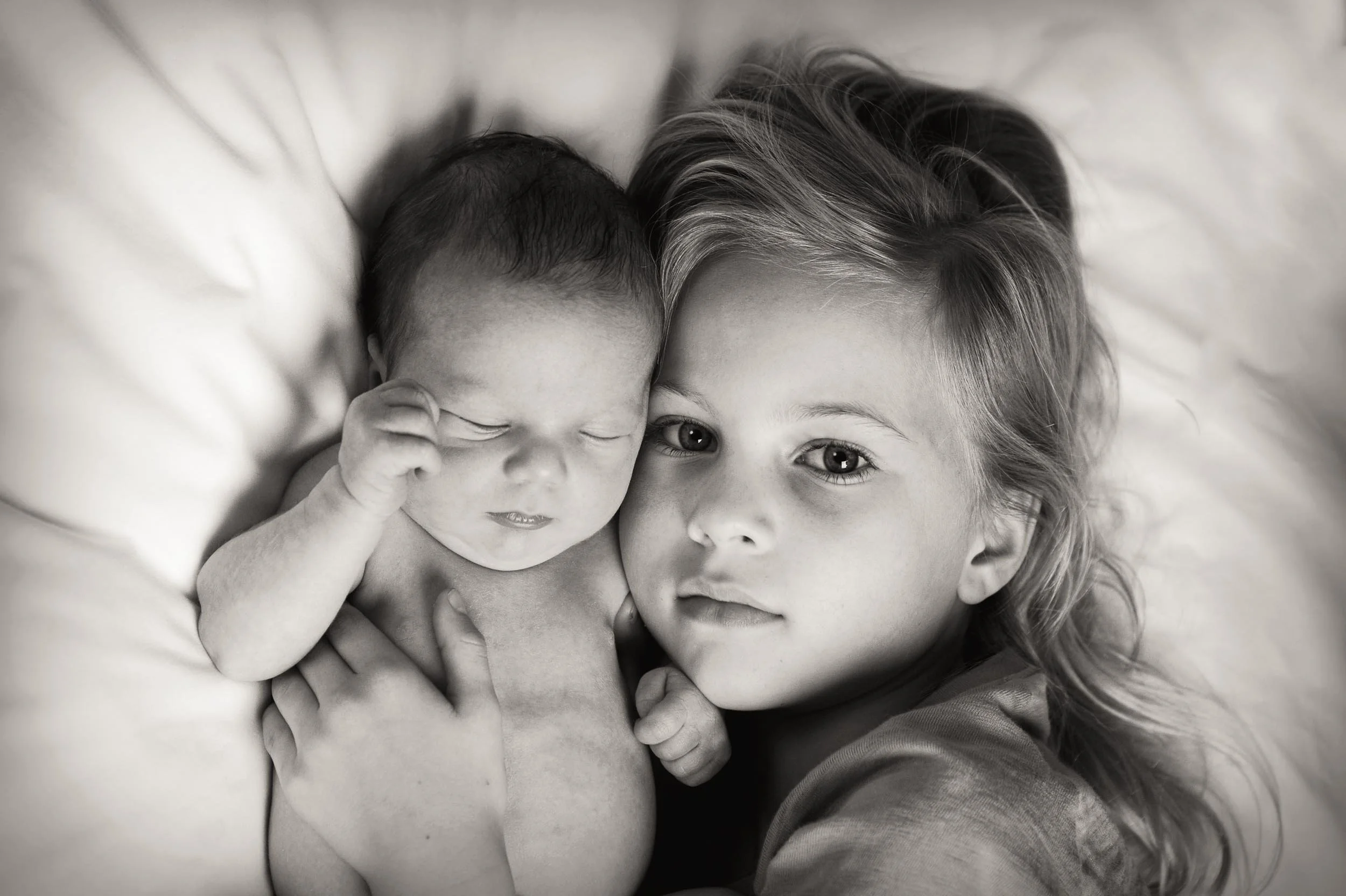 family newborn photography of 3 day old and big sister cuddling