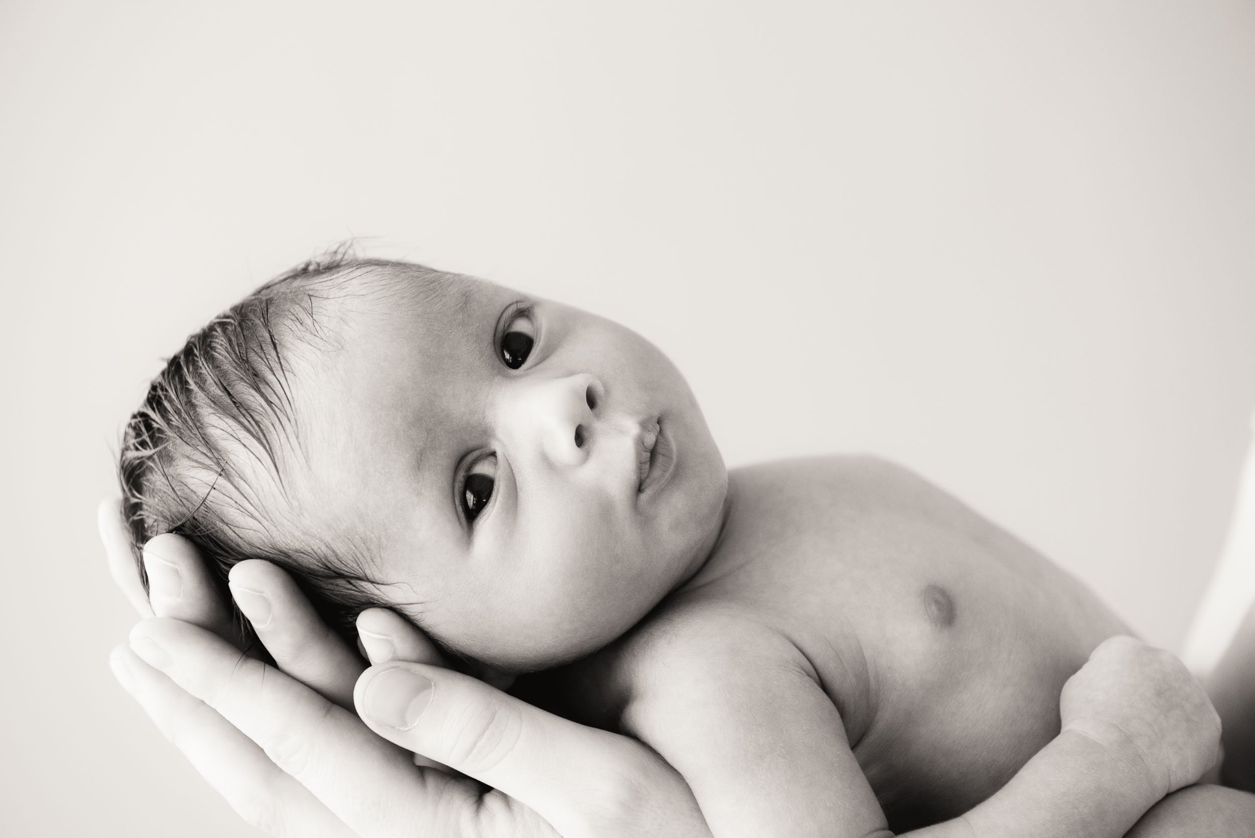 baby lying in mother's hands