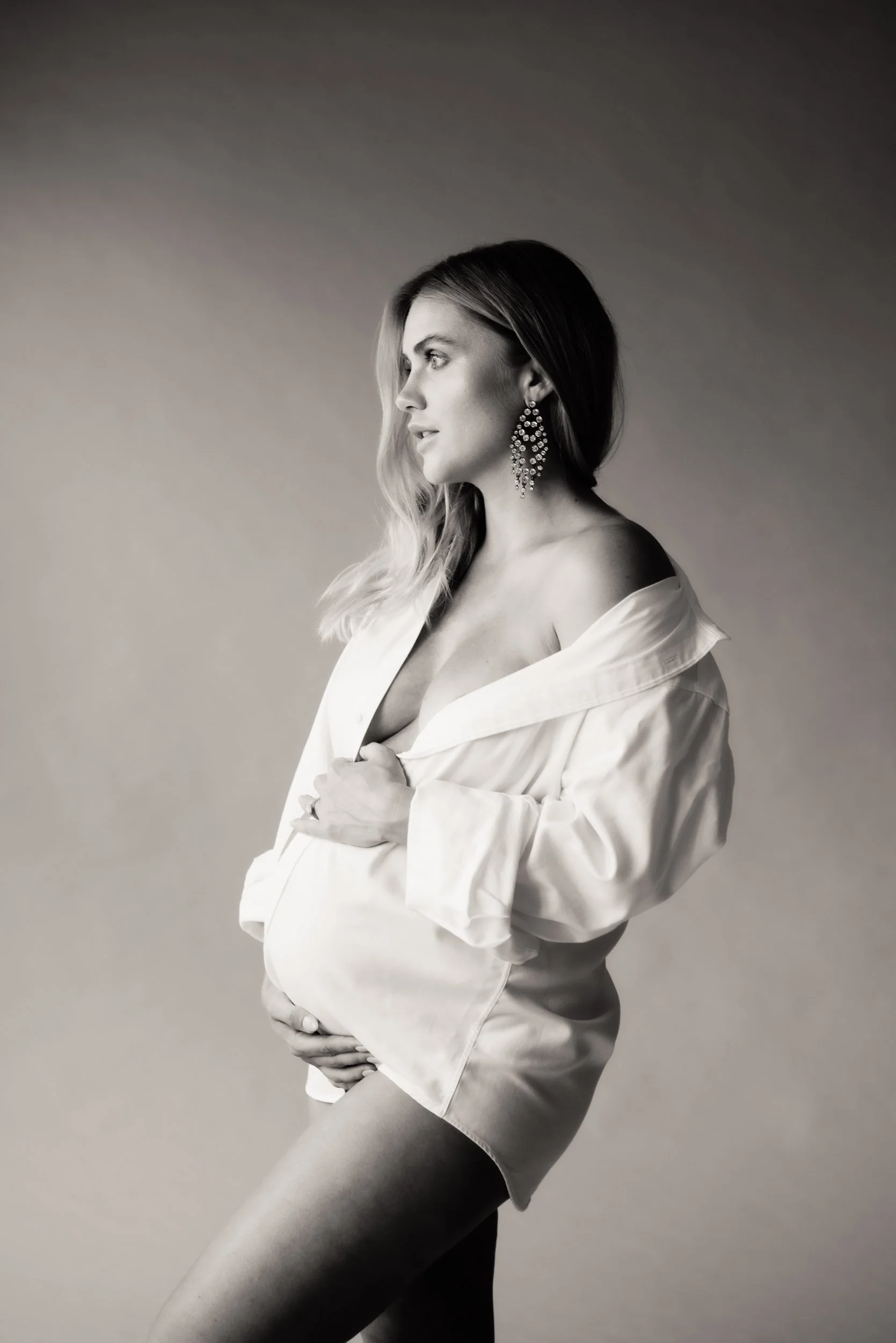 woman in white shirt posing for a maternity photoshoot in sydney