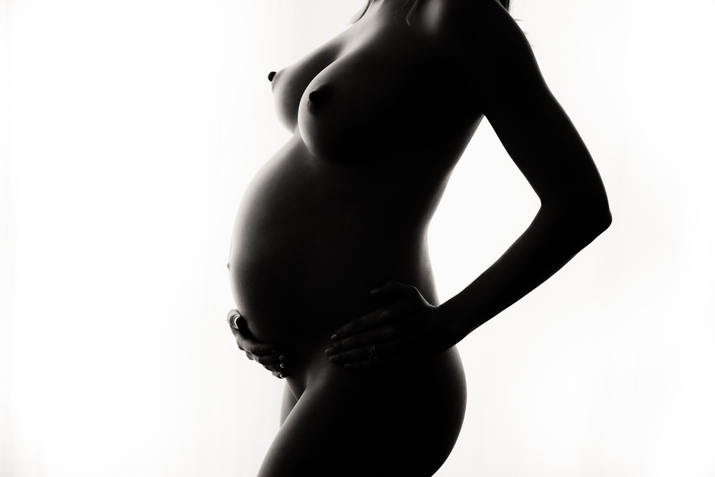 elegant nude maternity photoshoot of close up belly