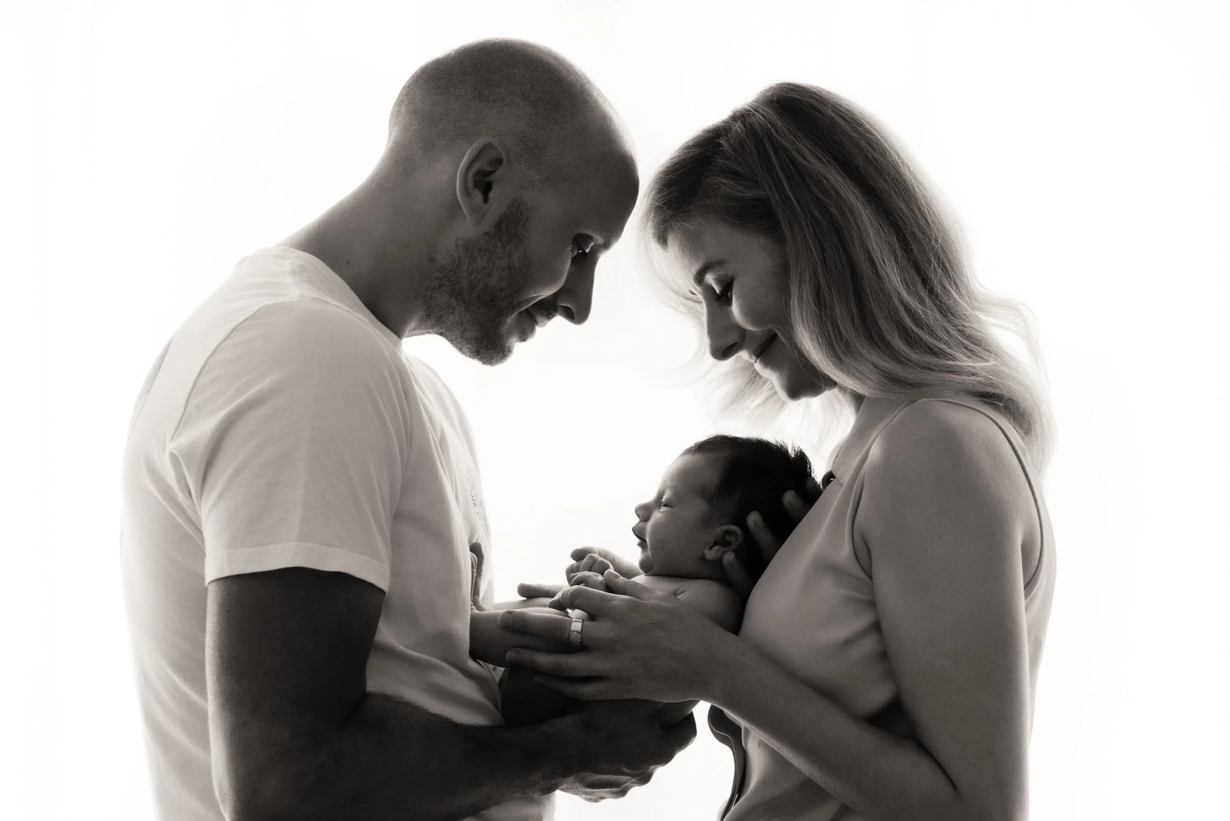 mother and father holding baby for a newborn photoshoot
