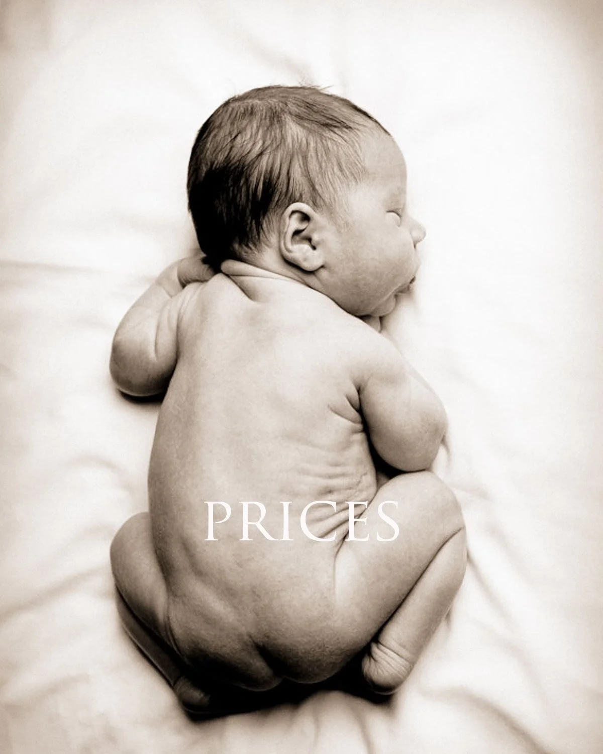 A black and white photo of a newborn baby lying on a soft surface, curled up in a fetal position, with the word 'PRICES' written over the baby's lower back.