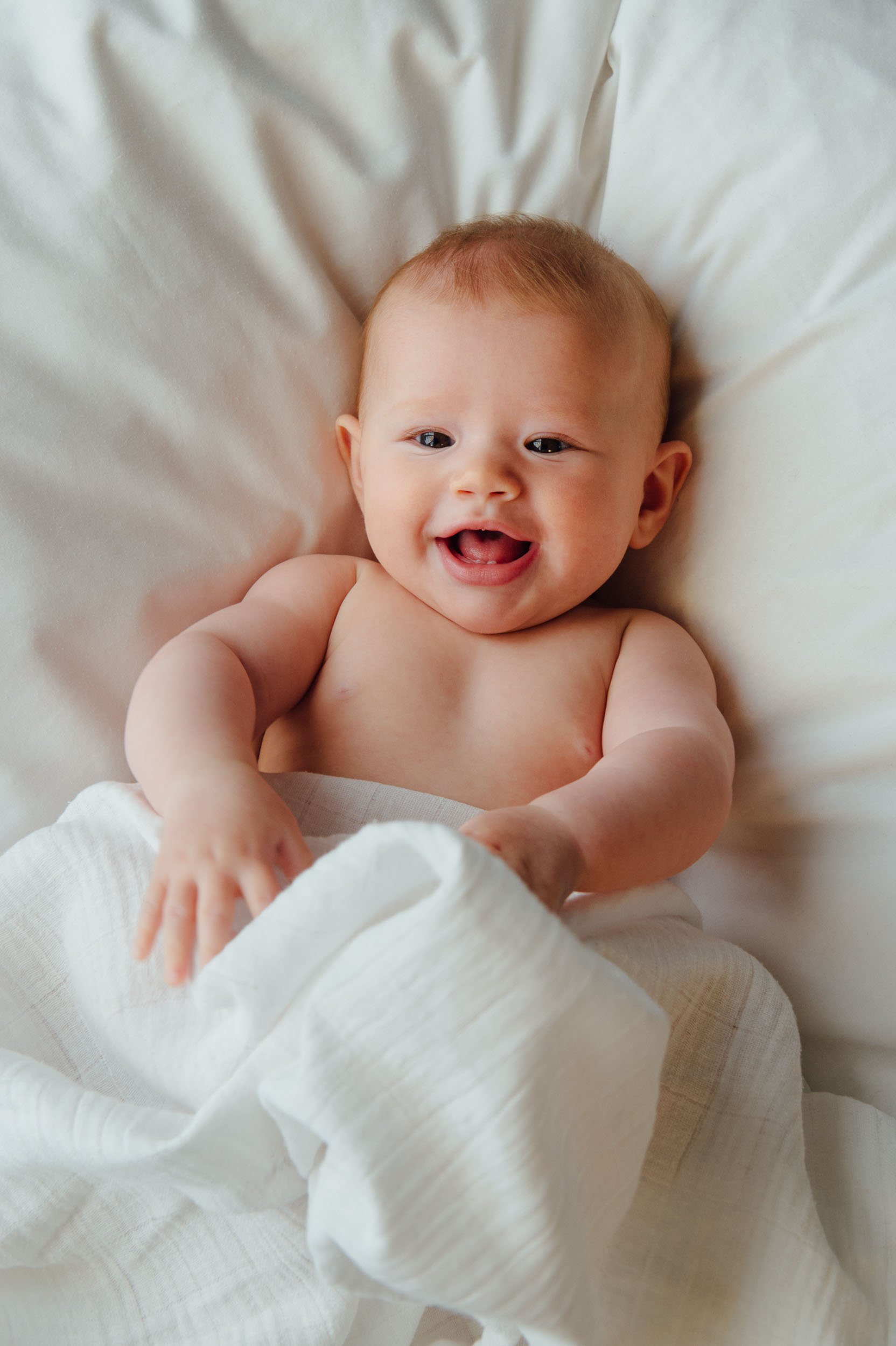 5 month old laughing during a baby photoshoot