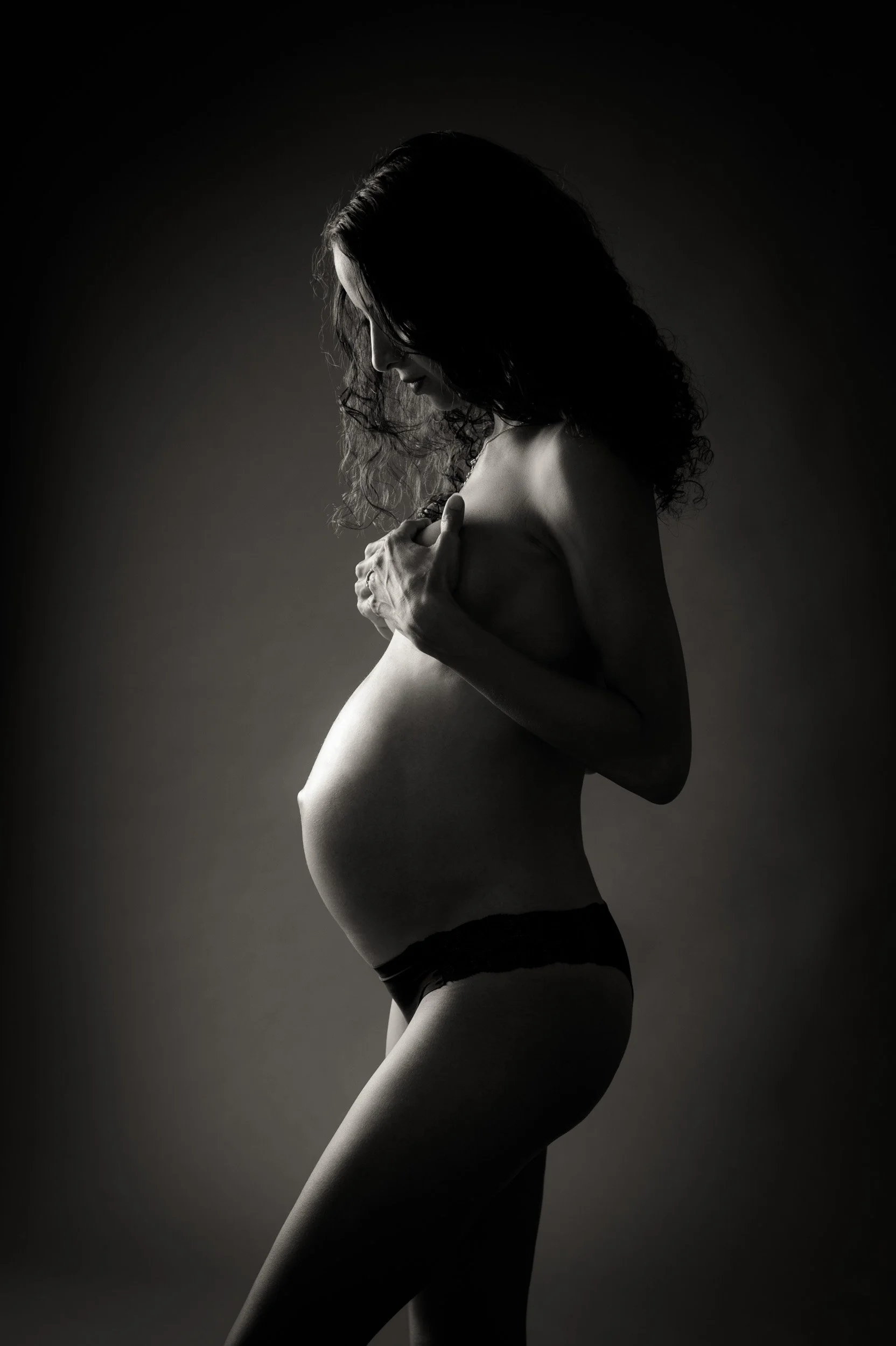 Maternity portrait with moody lighting in Sydney studio
