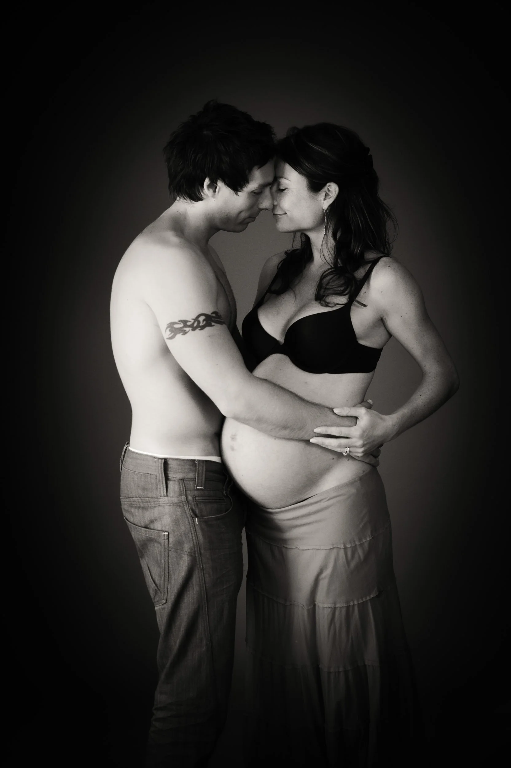 partners dancing during a maternity photography studio session