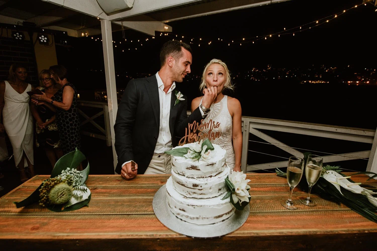 fun Wedding cake cut of bride tasting the cake from grooms finger 
