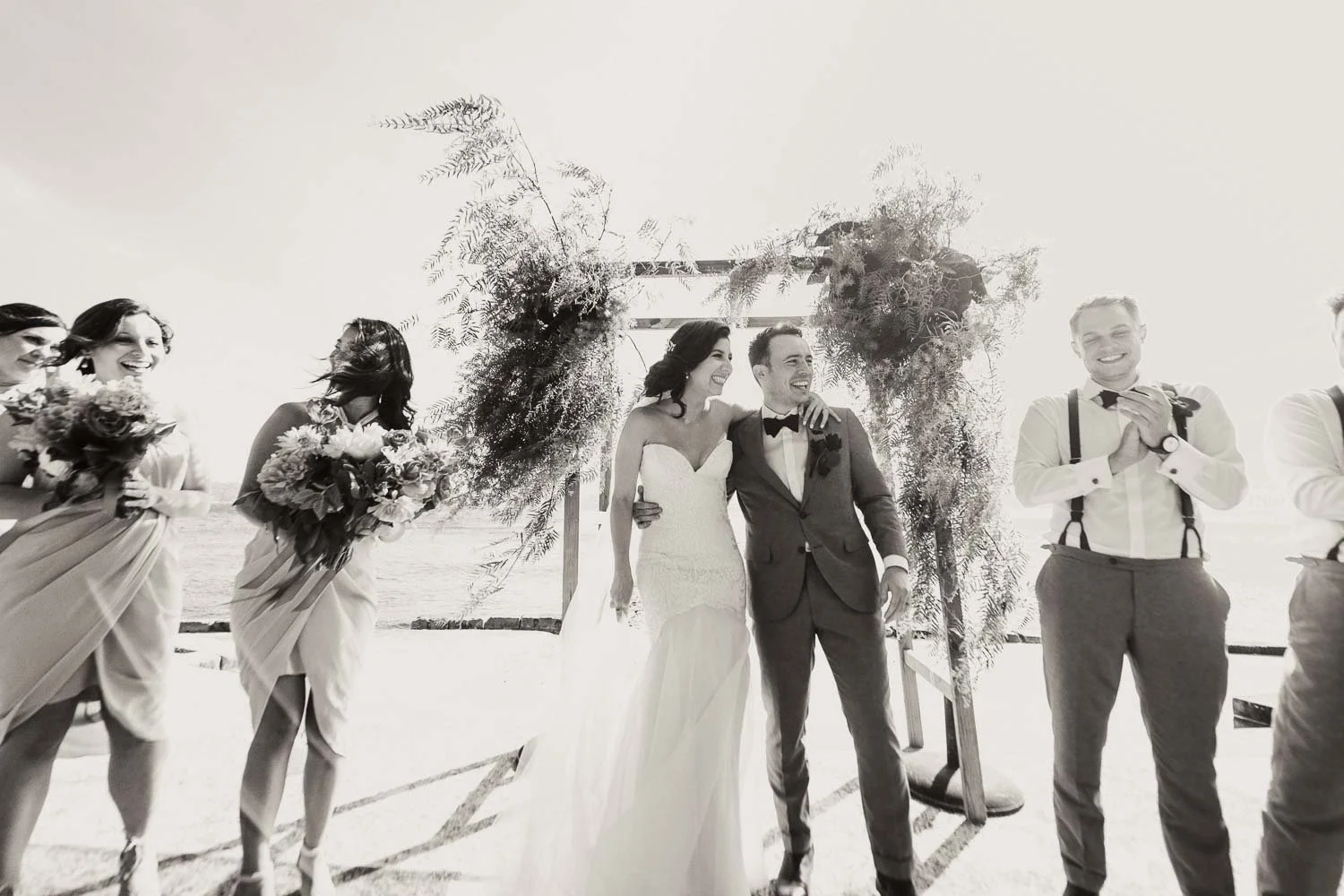 Just married bride and groom smiling with bridal party  wedding ceremony at Bradleys Head in Mosman Sydney 