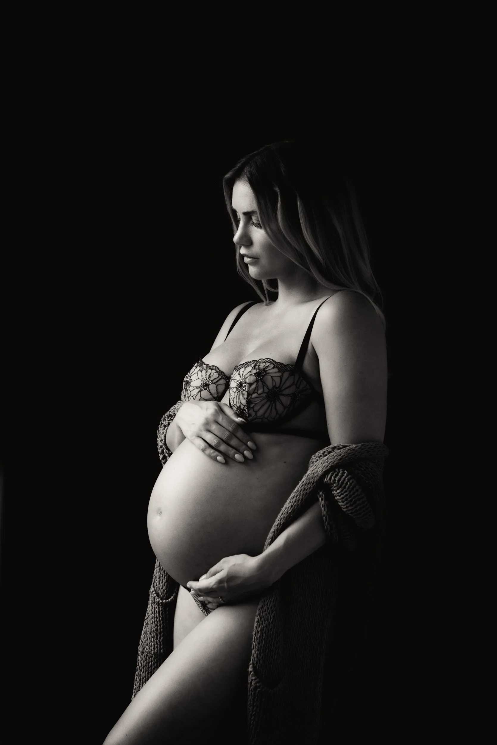 artistic maternity portrait of a woman in lingerie and shawl 