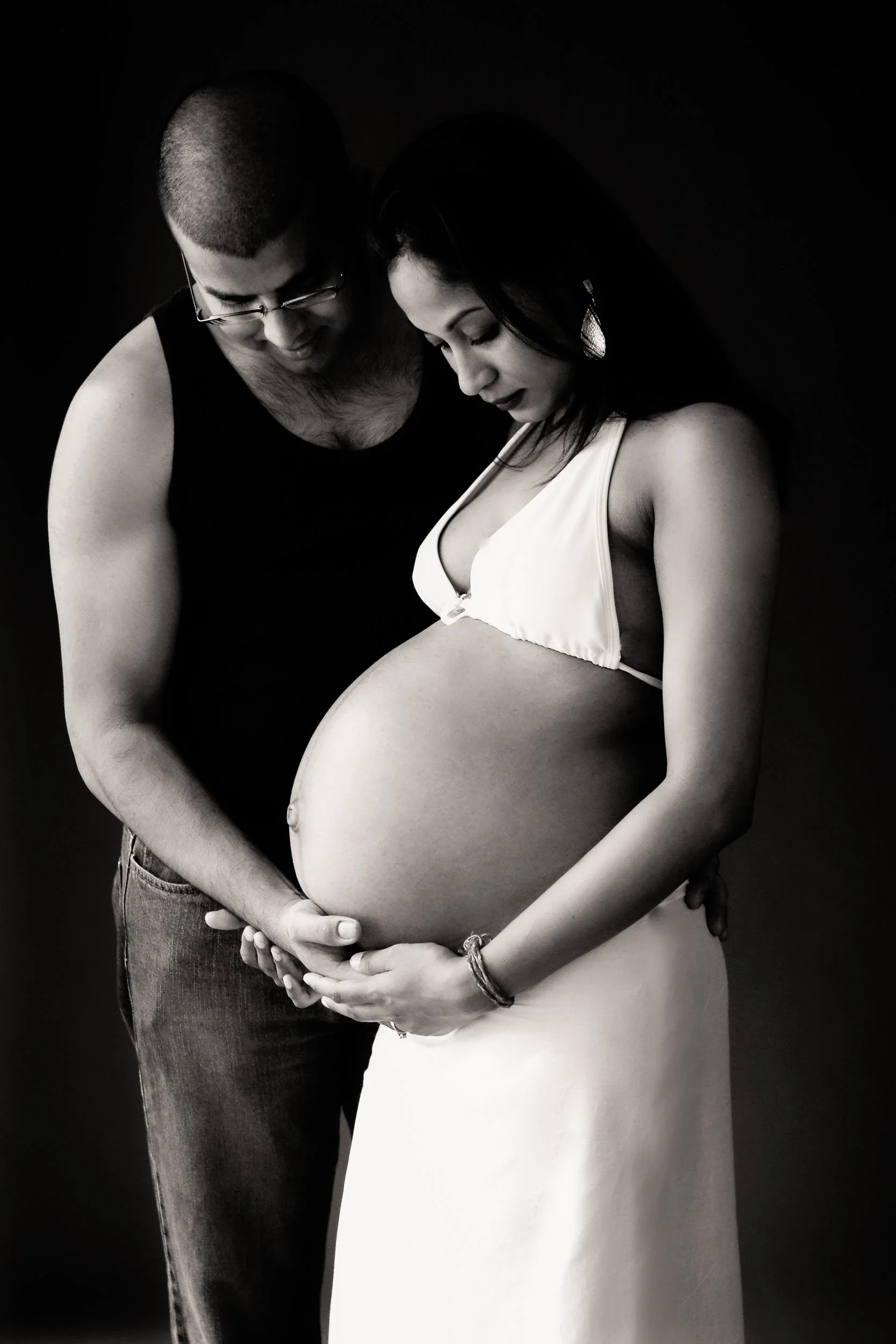 couple maternity portrait together holding belly