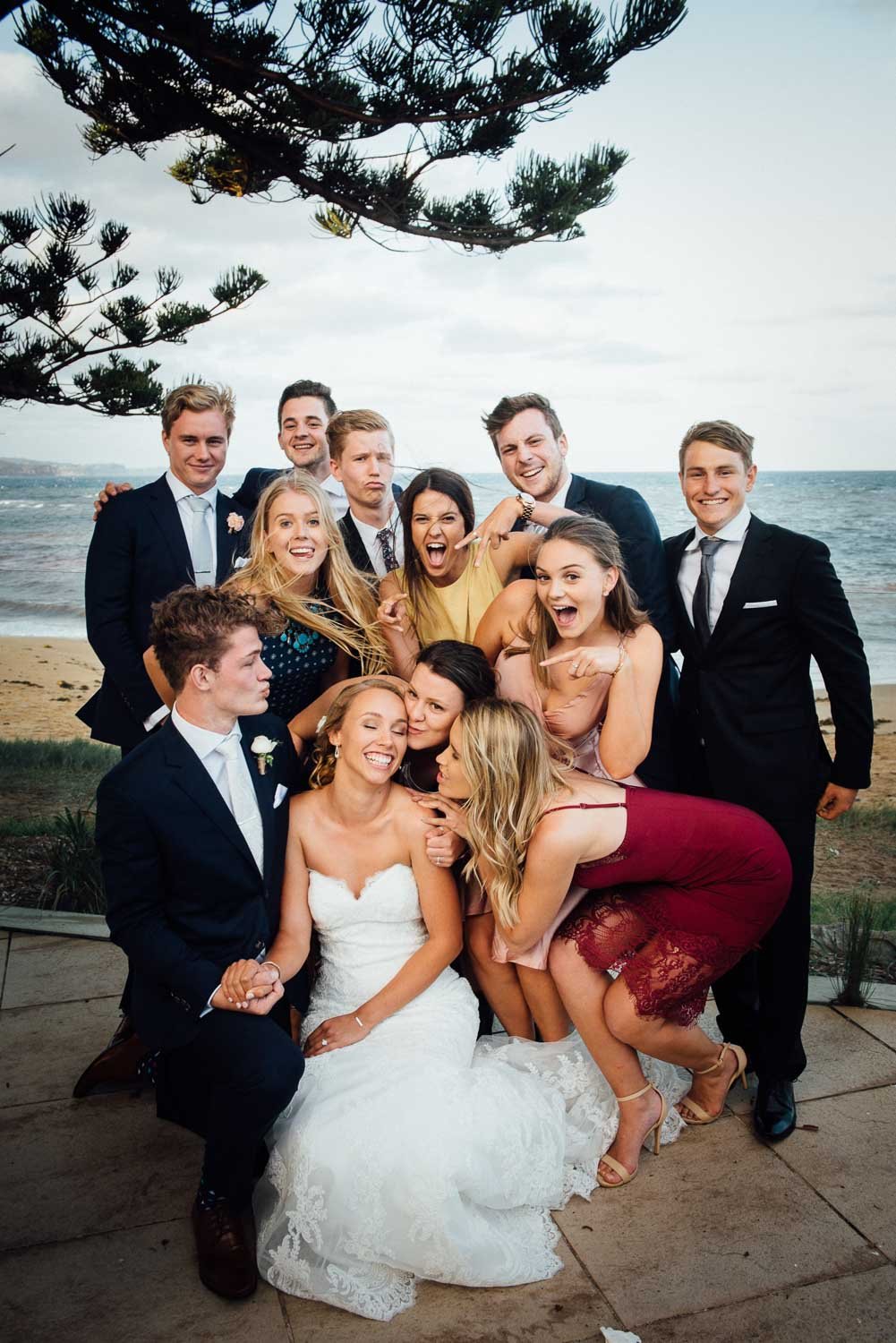 fun bridal party admiring bride and groom
