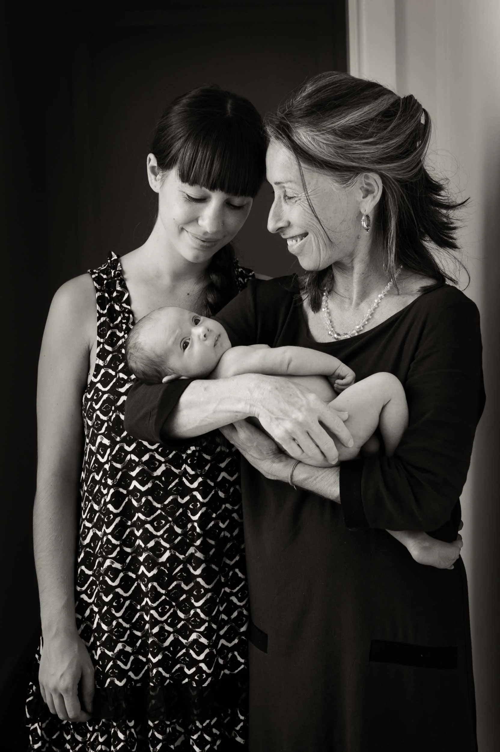baby photoshoot of grandmother, mother and daughter smiling
