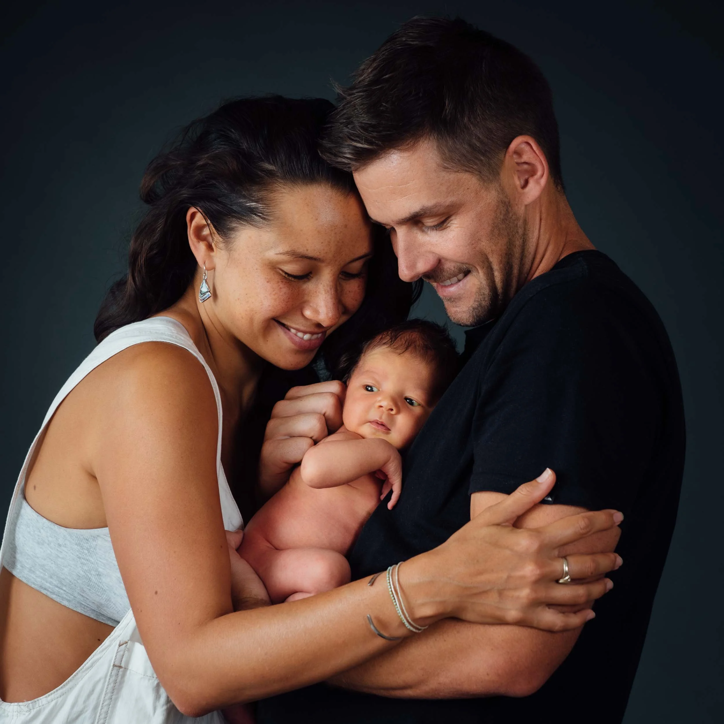 newborn photography family shoot of parents cuddling baby