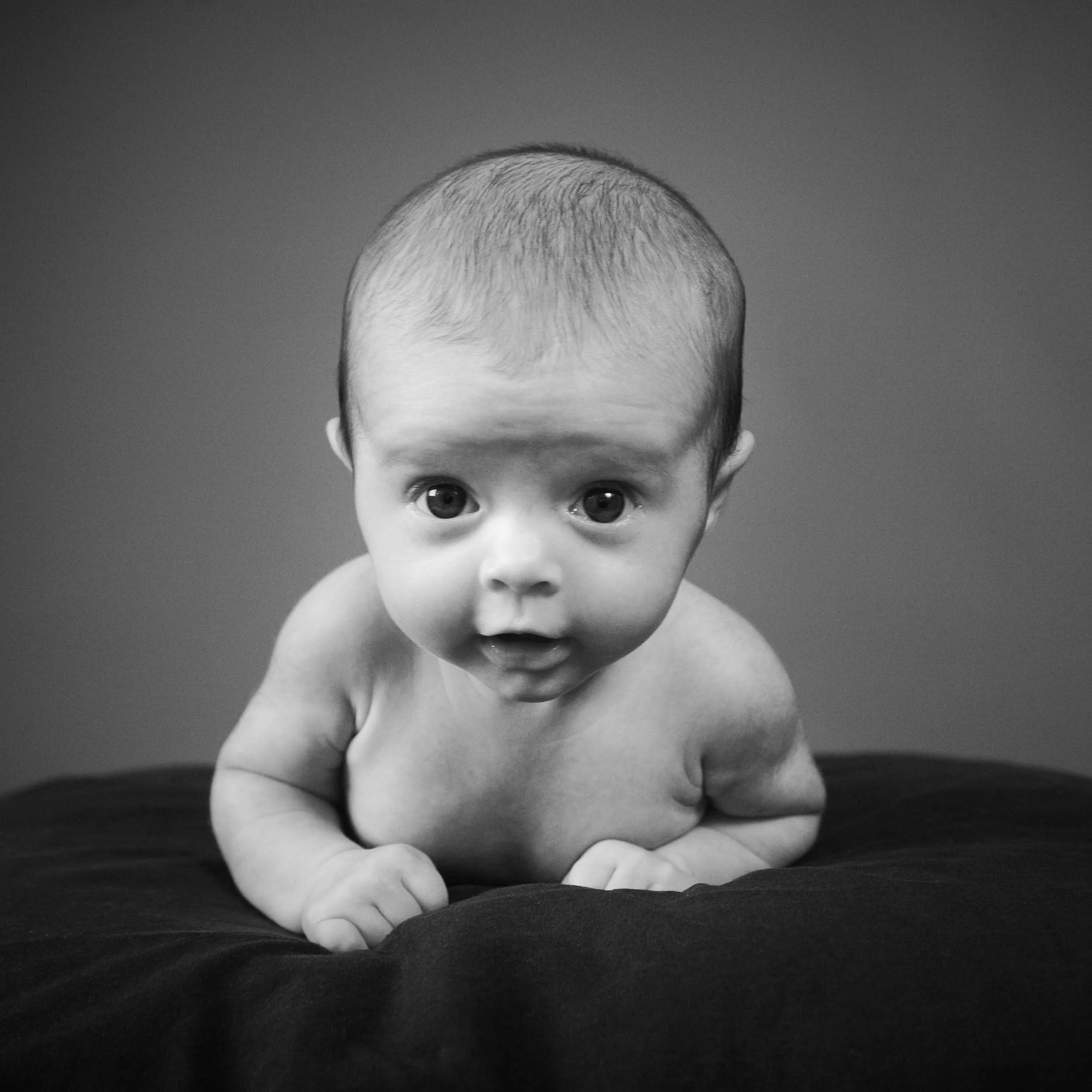 studio baby photography of boy lying on his tummy