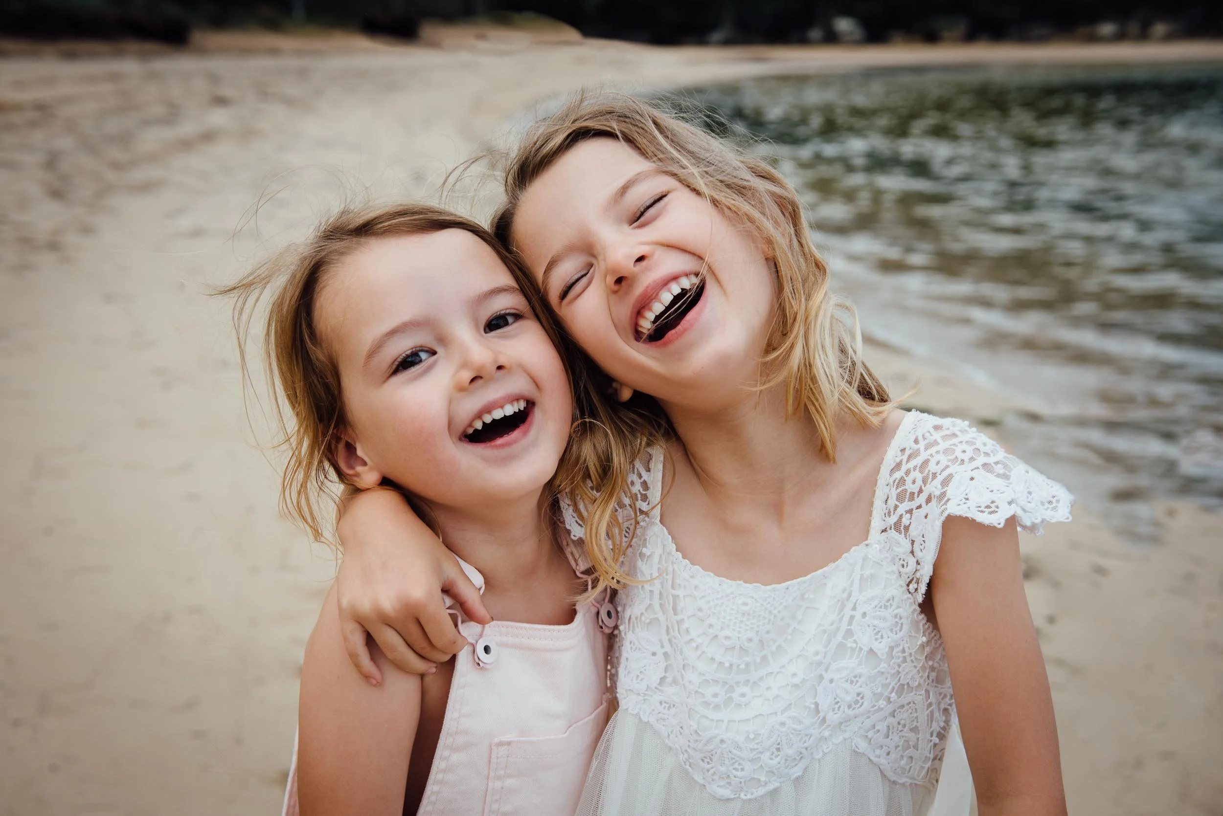 Lifestyle photography of sisters laughing at Palm Beach