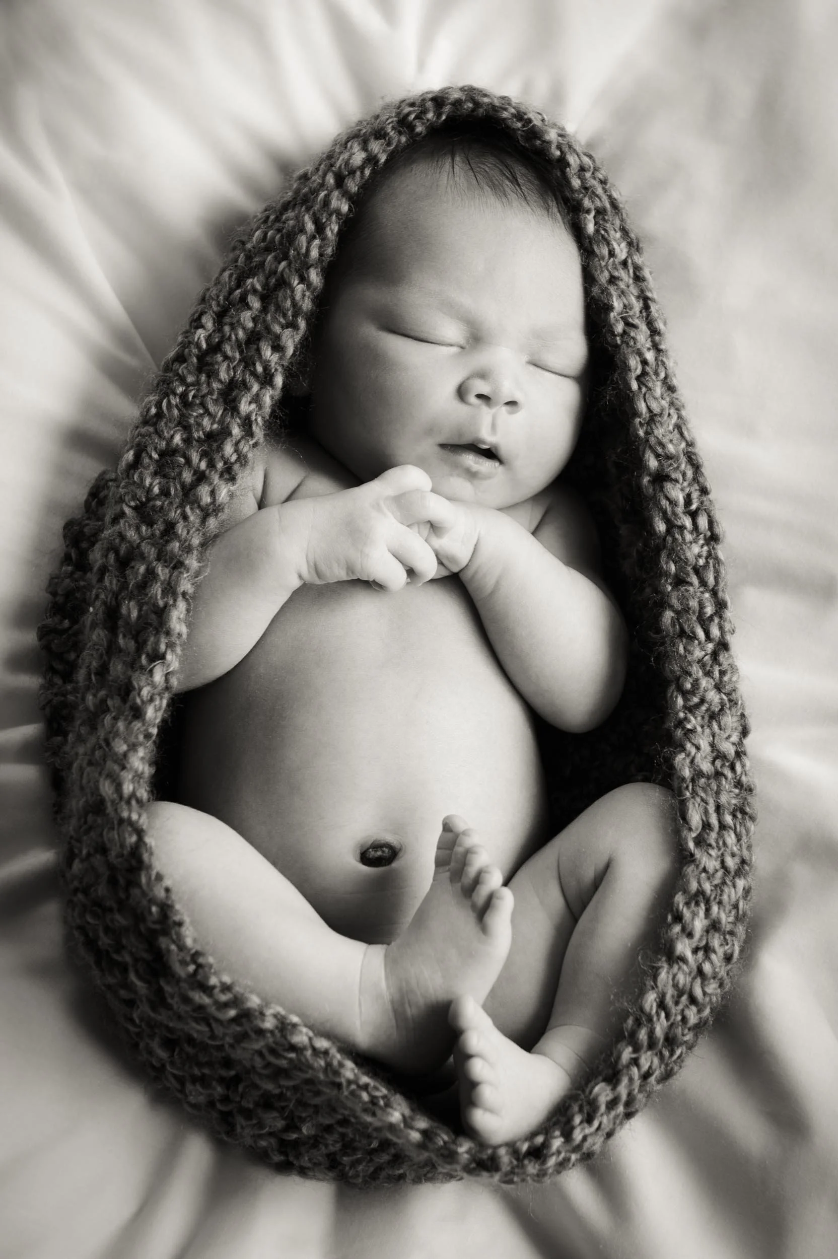 baby sleeping in cocoon during a newborn photography session