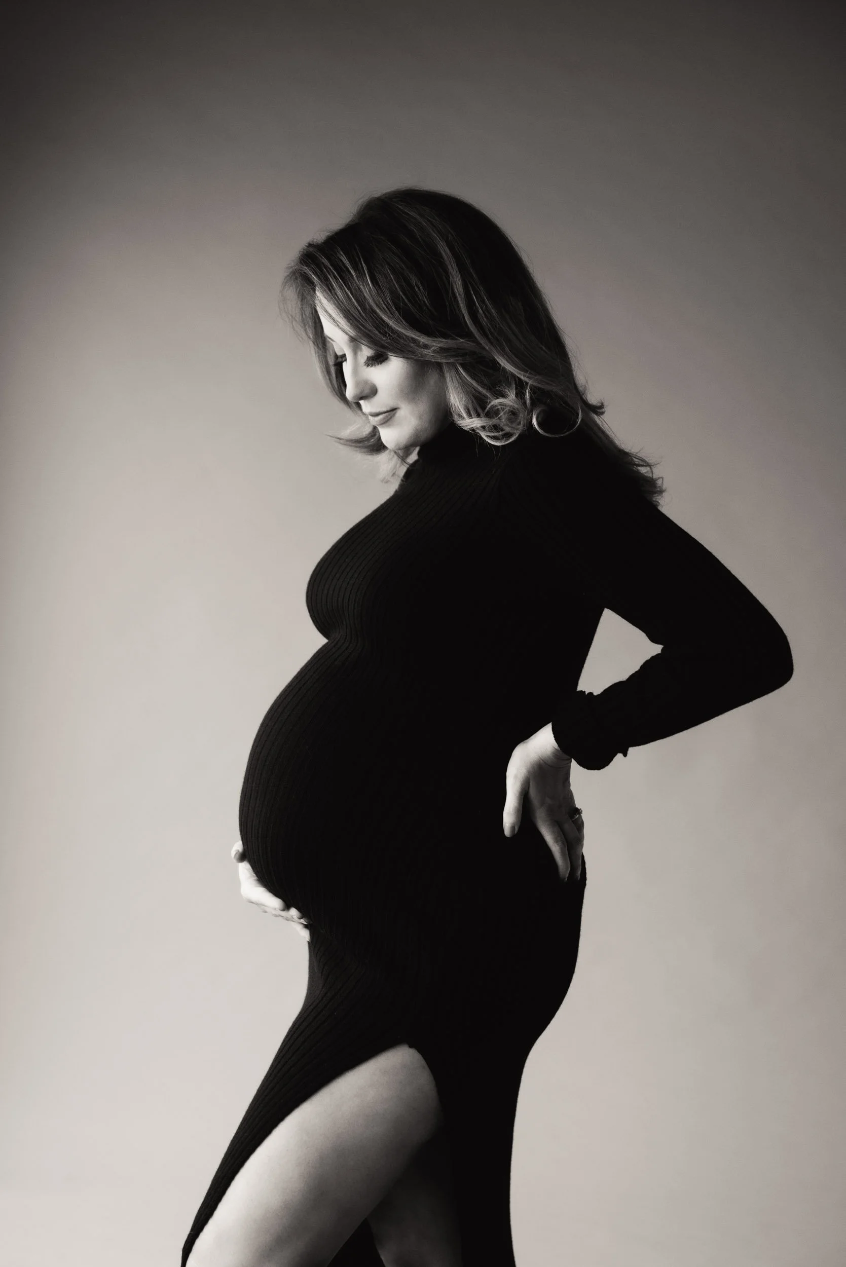 woman in tight black dress for a maternity photography Sydney shoot