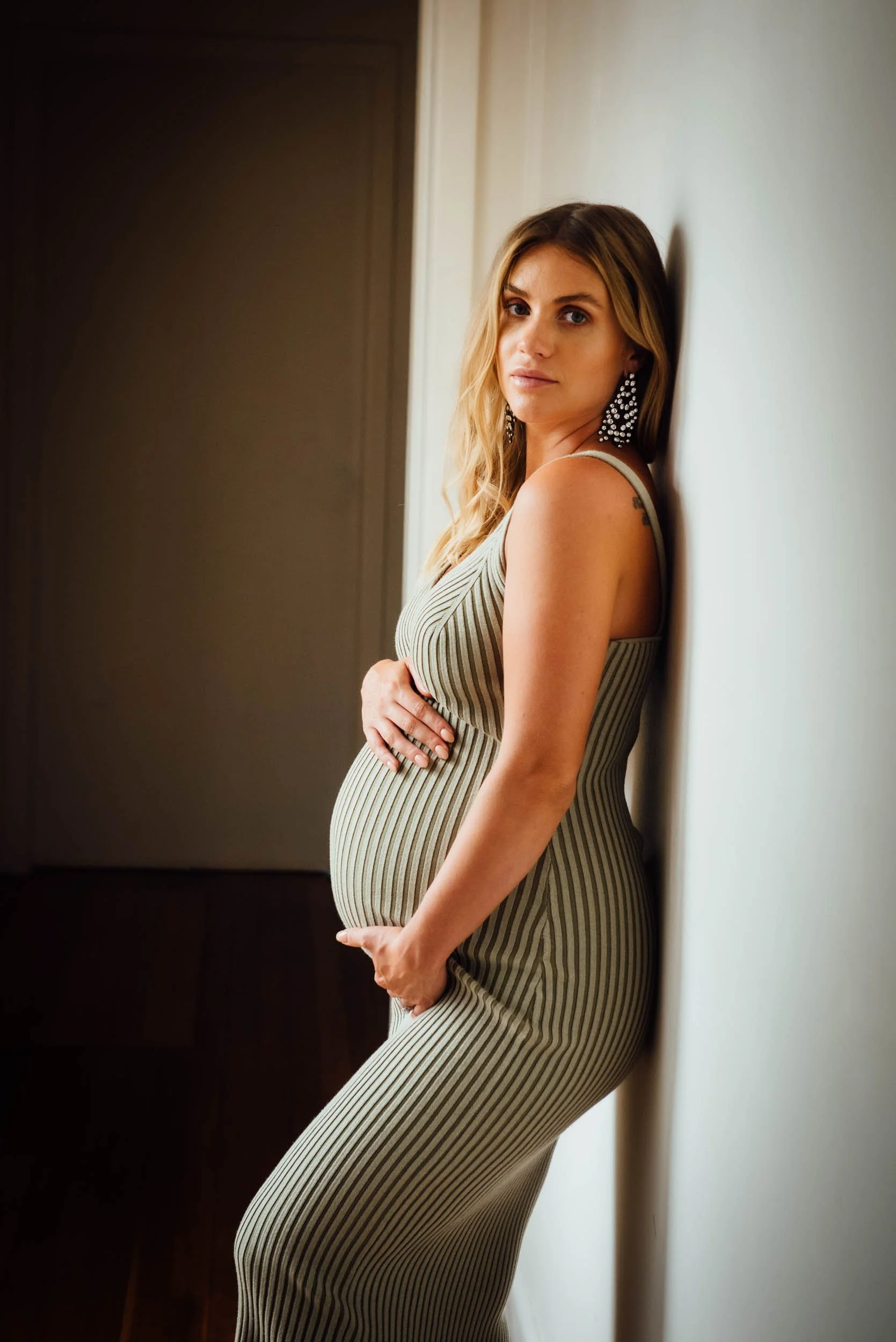 Studio Pregnancy Photography of woman in tight green dress