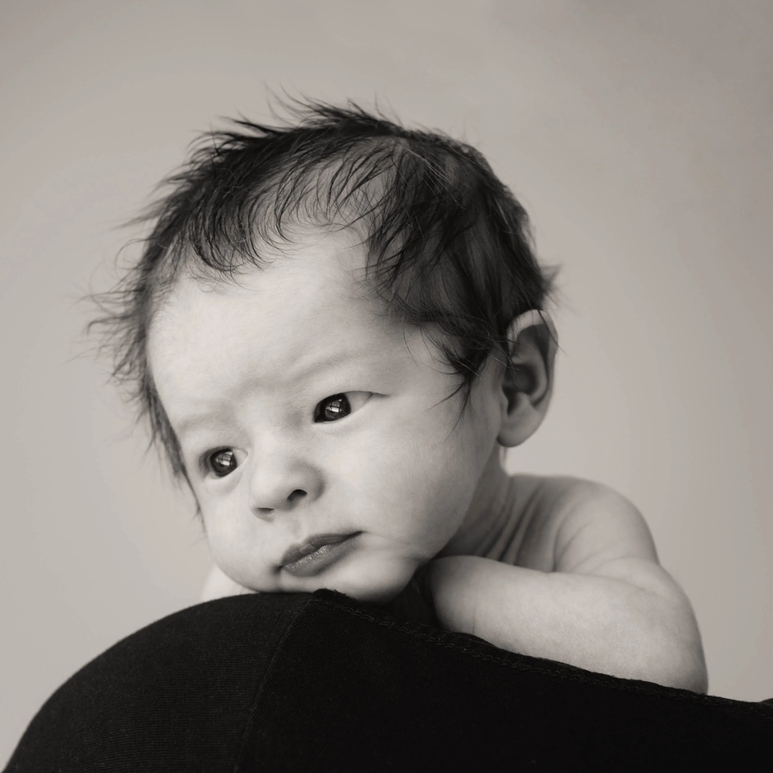 newborn looking over parent's shoulder