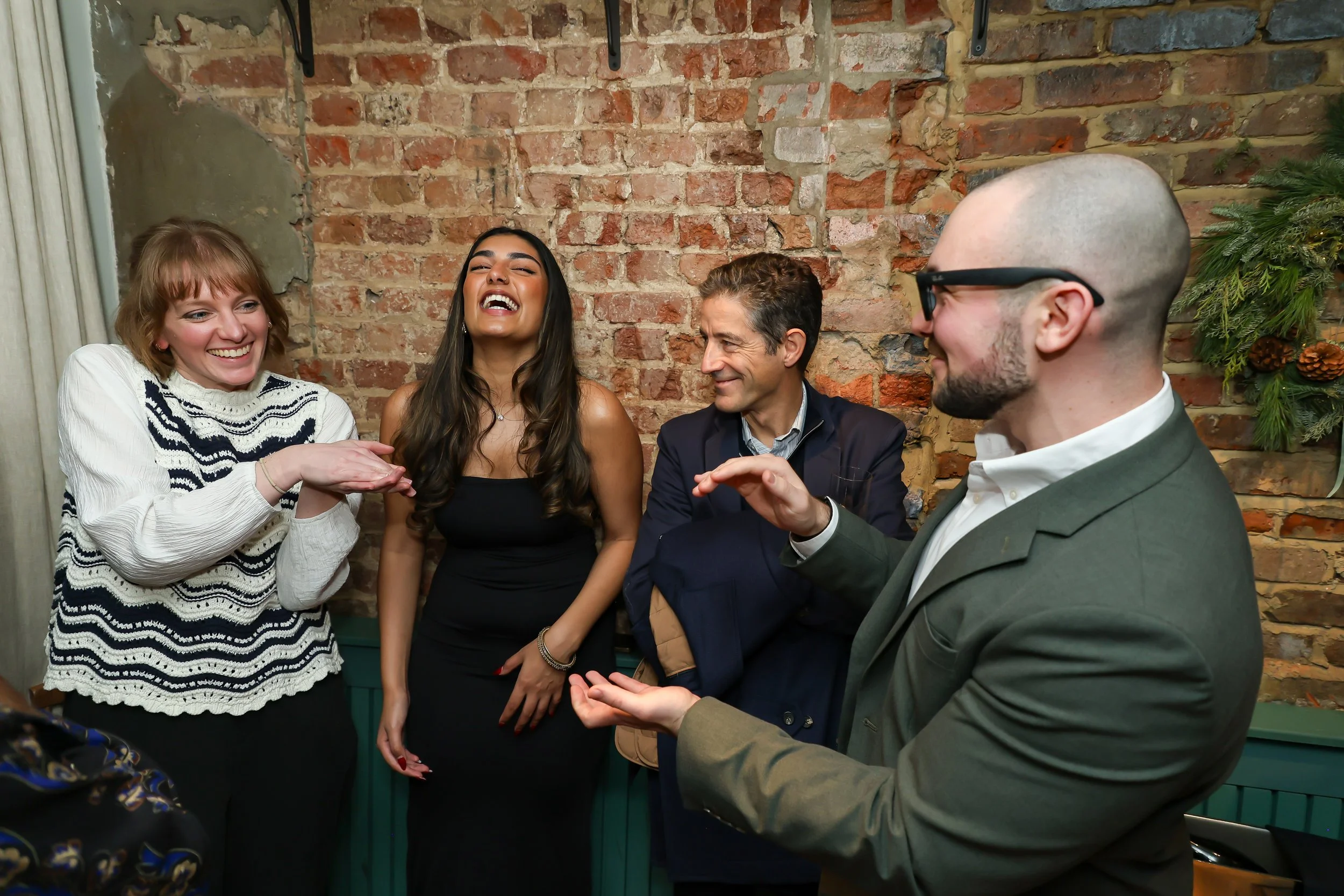 Corporate guests enjoying hands-on magic entertainment during the dinner event.