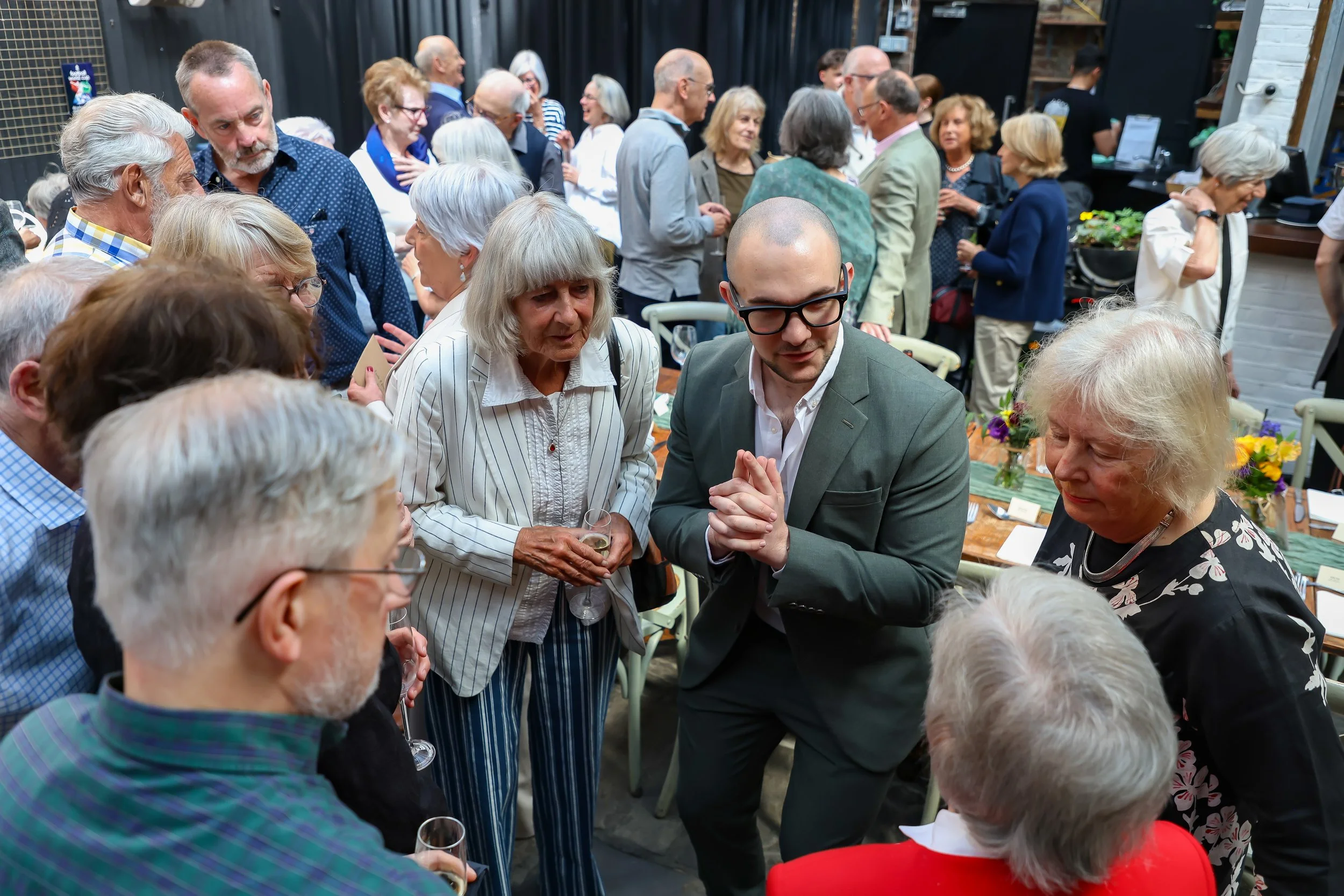 Magician with his card trick. 2026-May 3 Rhoda & Baruch Golden Wedding Anniversary. 