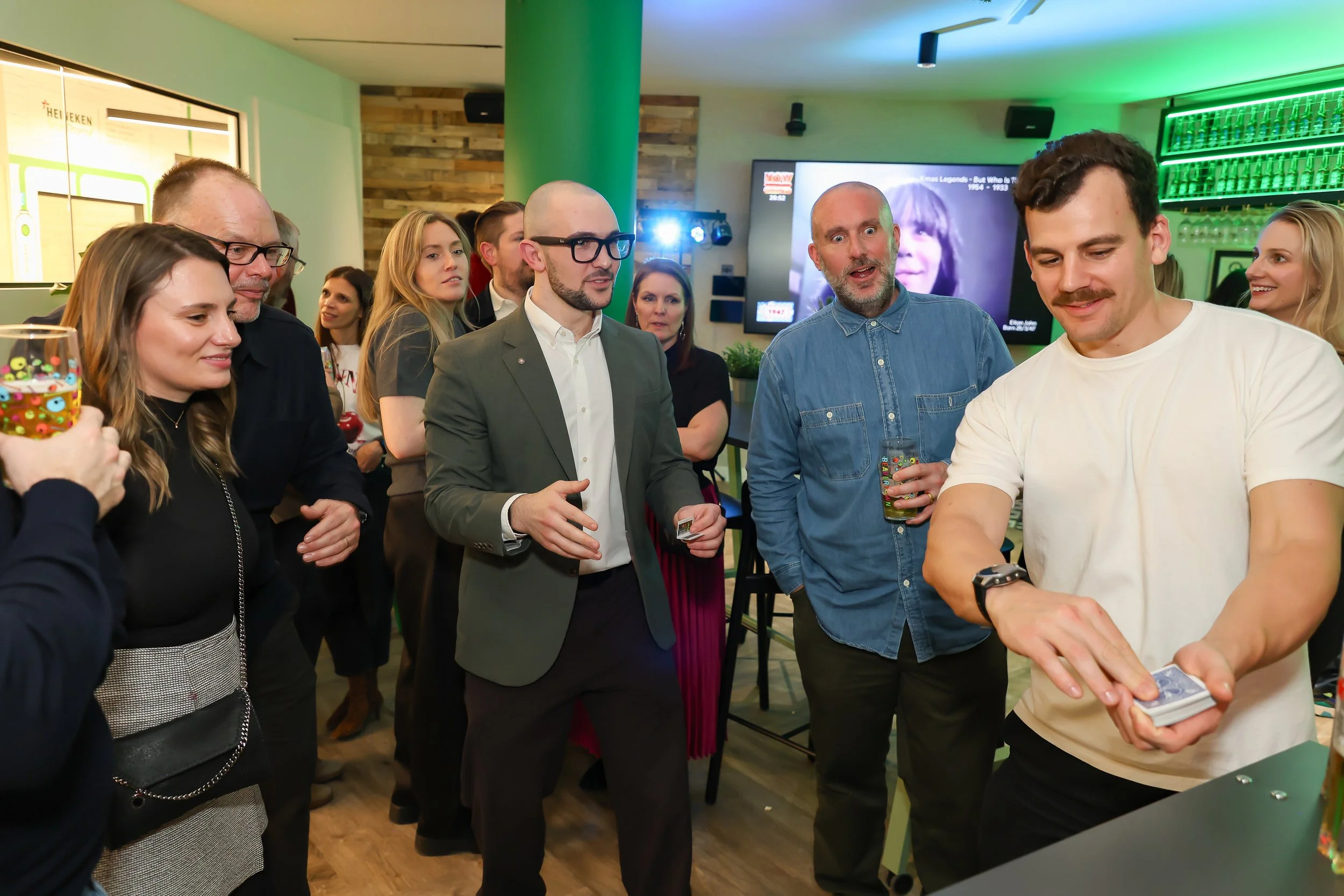 Christmas party entertainment with interactive magic and laughter among corporate colleagues.