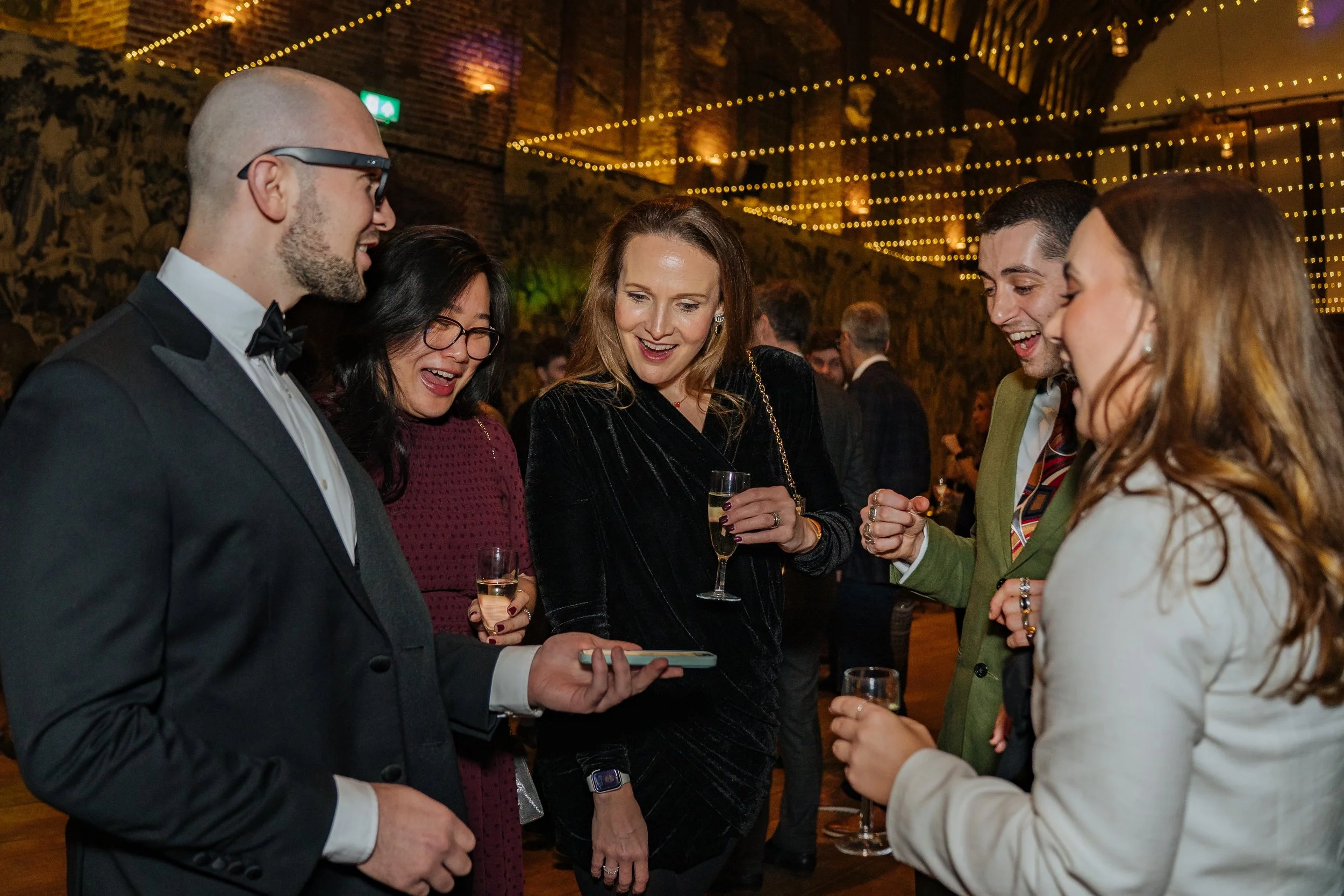 Magician entertaining corporate guests with hands-on illusions, creating laughter and amazement during the dinner event.