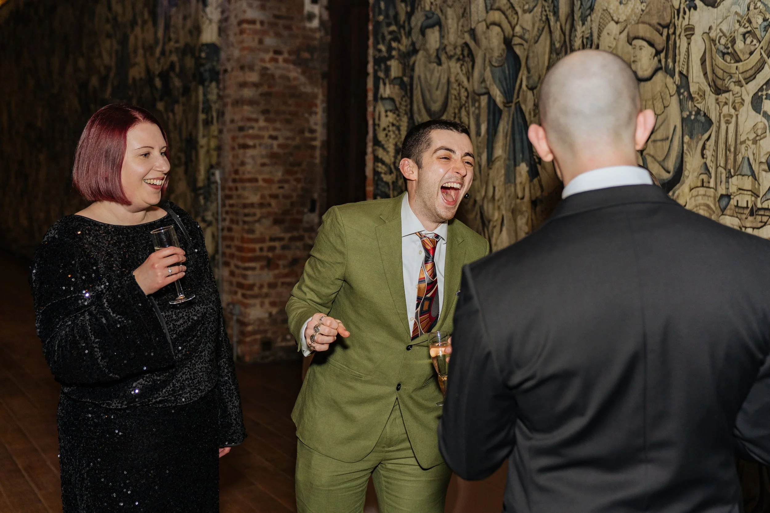 Magician performing close-up magic for a small group of corporate guests during a gala reception.