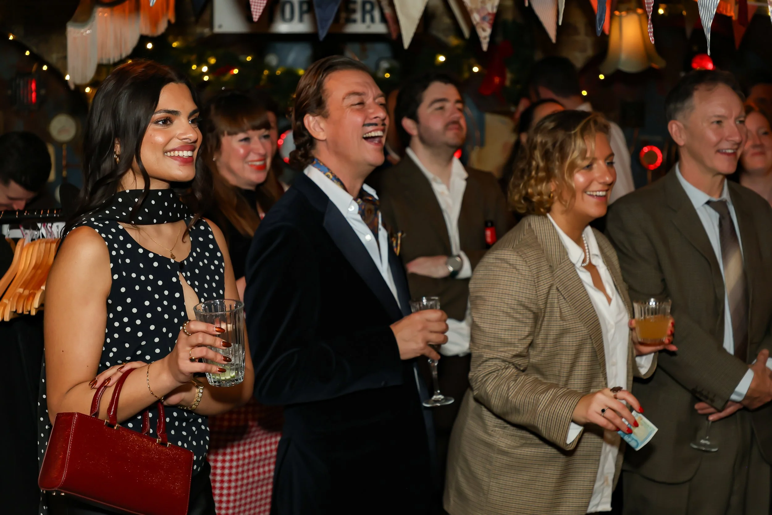 Magician performing walk-around magic for guests at reception.