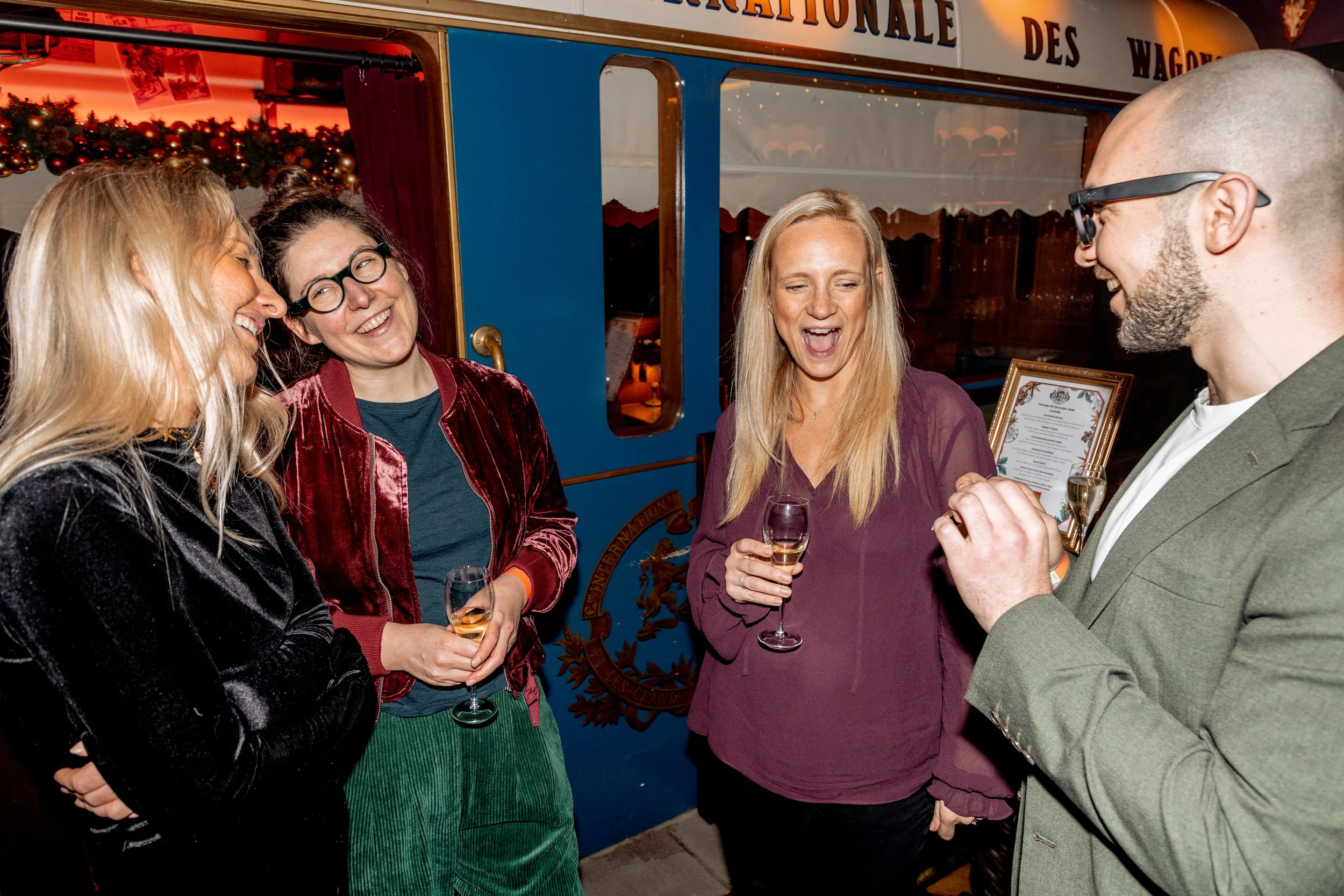 Corporate guests smiling during live magic performance.