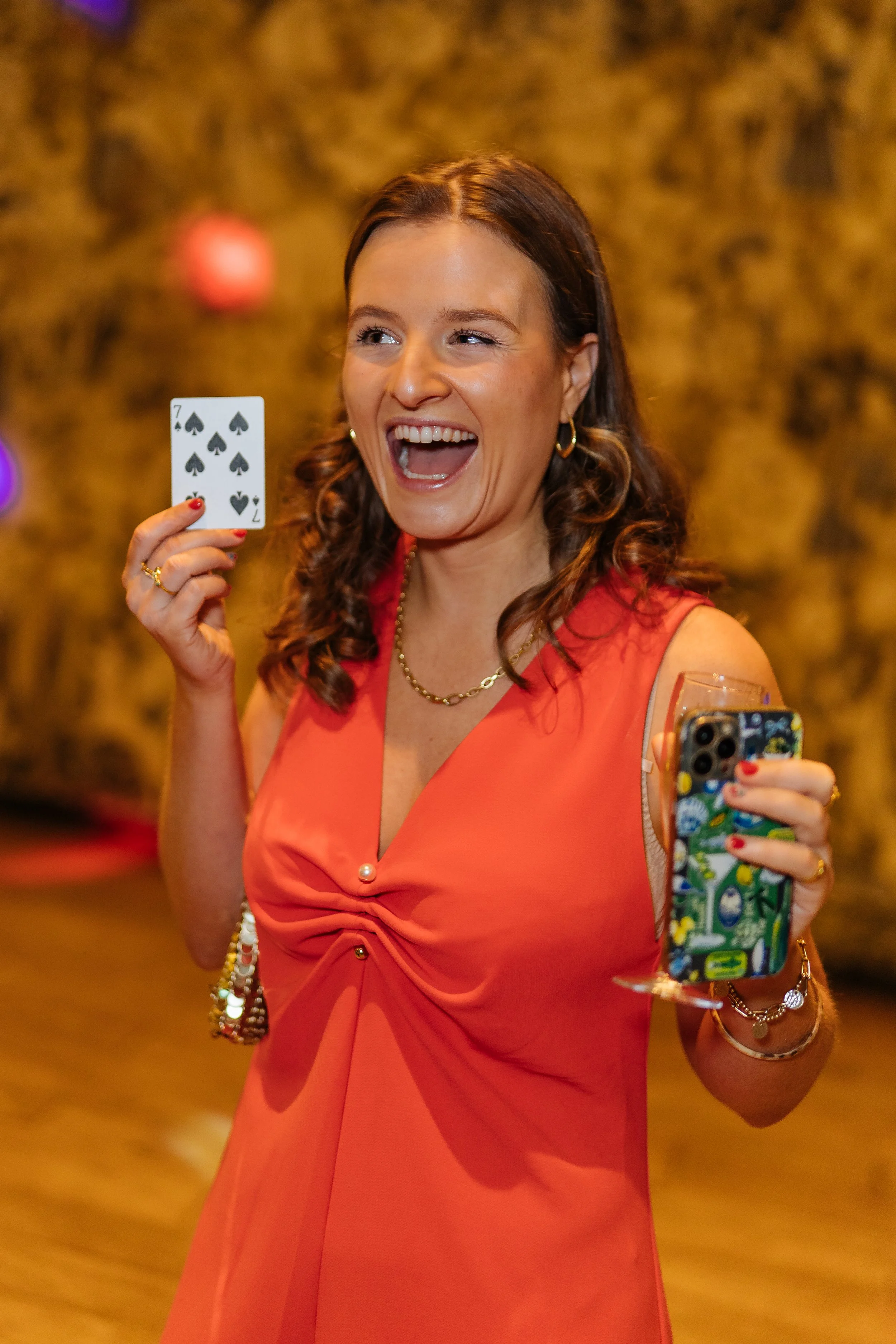 Corporate guest reacting to close-up magic during a formal event.