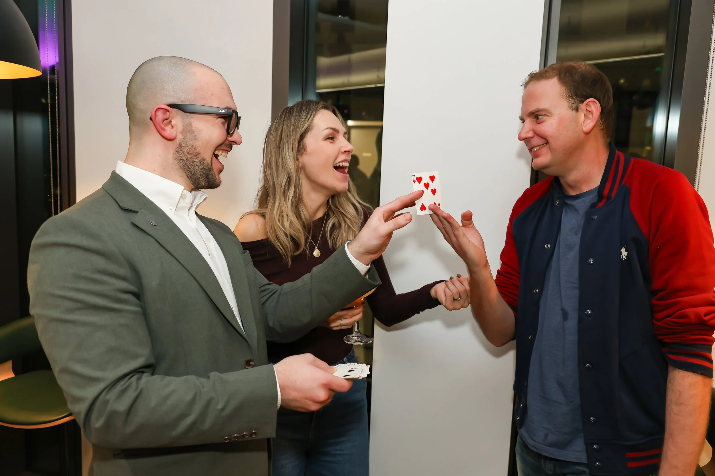 Interactive card trick performed by a magician at a corporate event.
