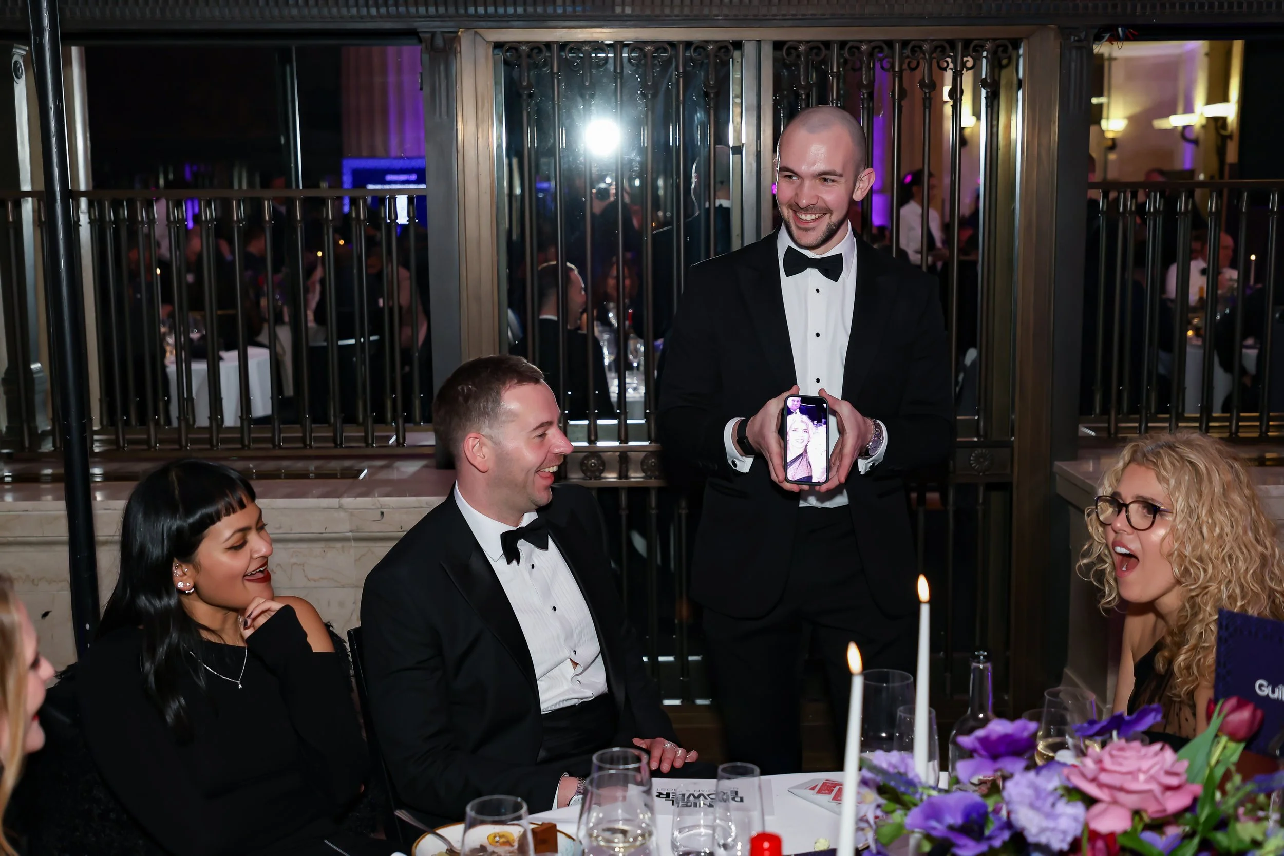 Table-side magic performance delighting guests during a corporate dinner.