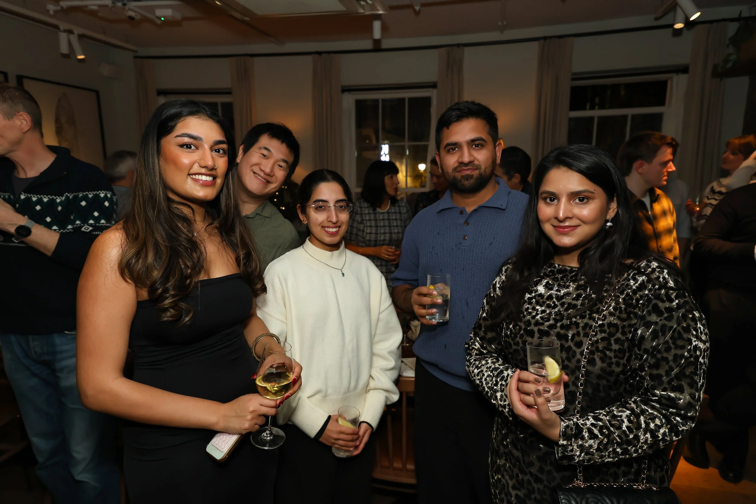 Happy corporate guests celebrating the close of a successful event.