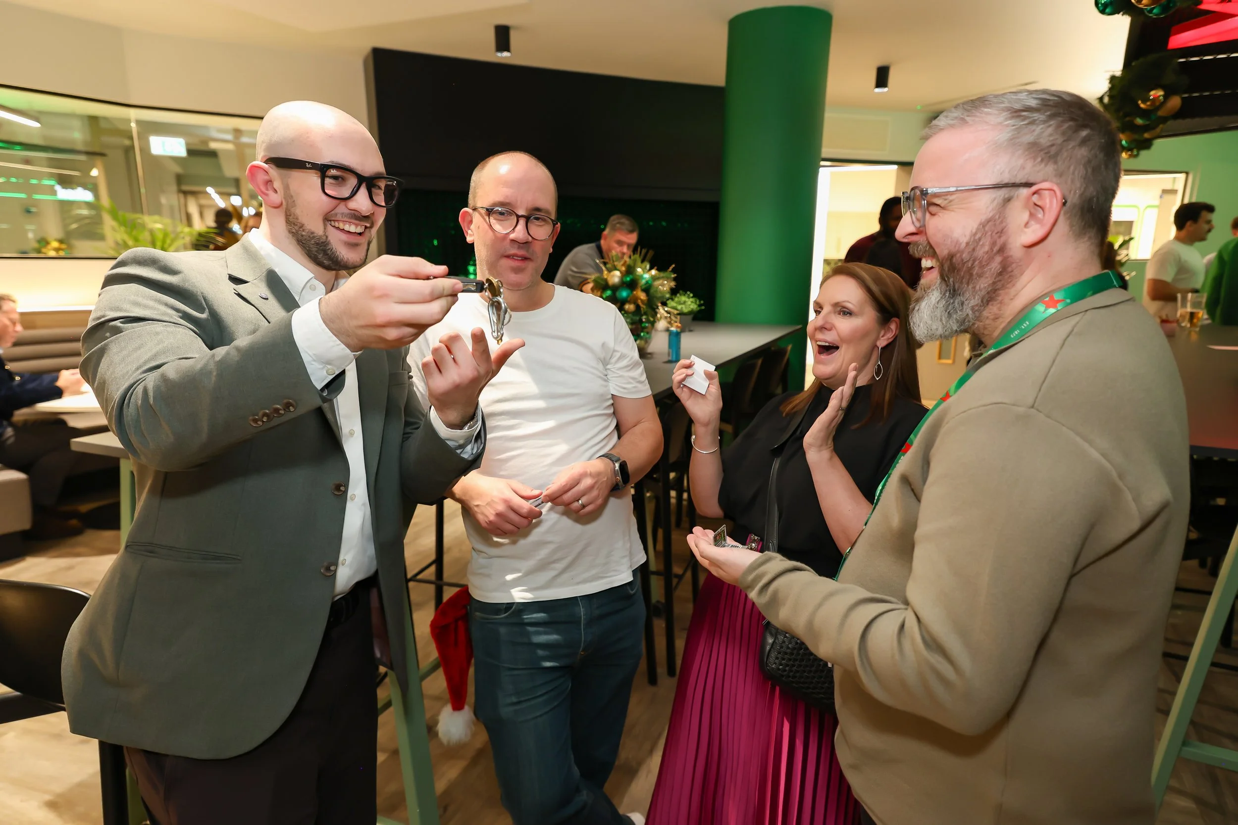 Corporate Christmas guests enjoy close-up magic during an informal drinks reception.
