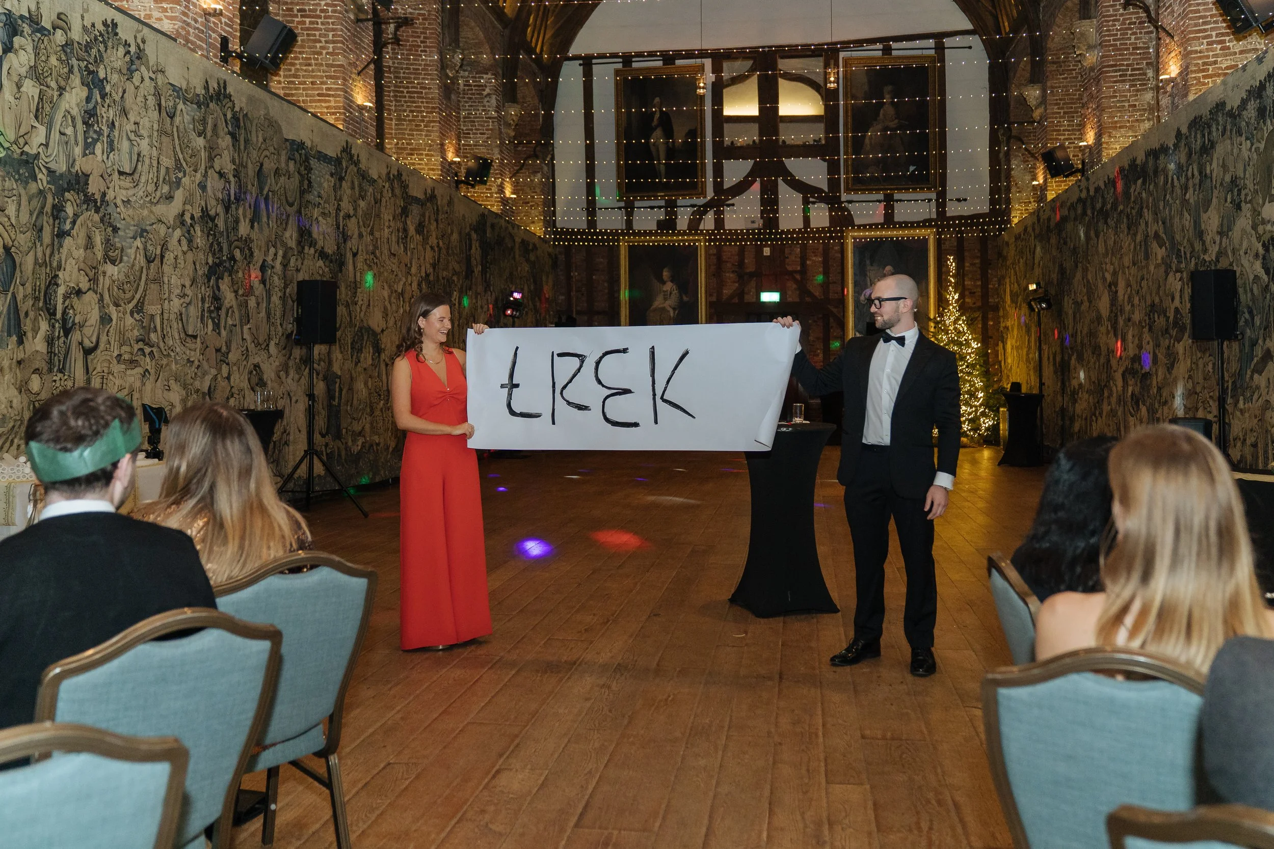 A corporate guest actively participating in a live magic performance, engaging with the magician on stage.