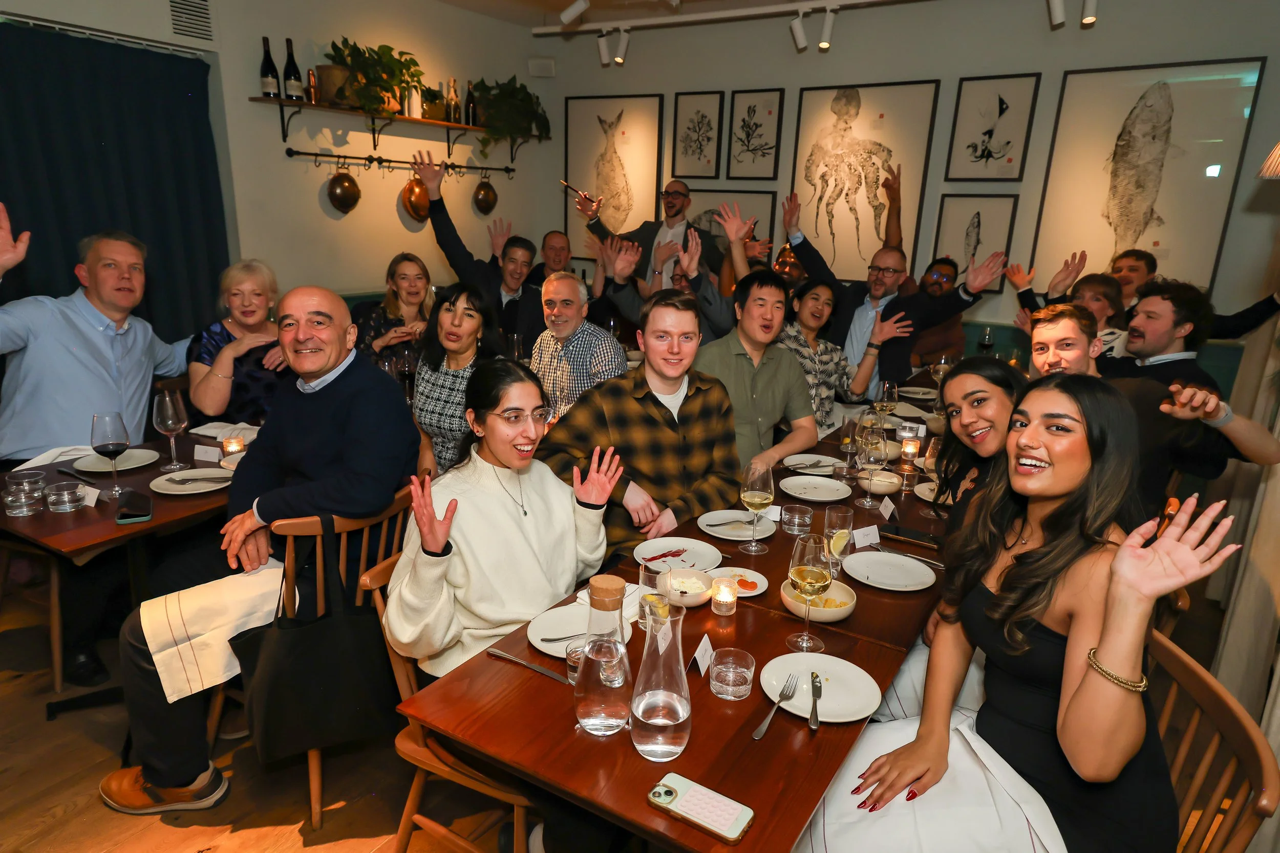 Magician wrapping up an engaging corporate party surrounded by happy guests.