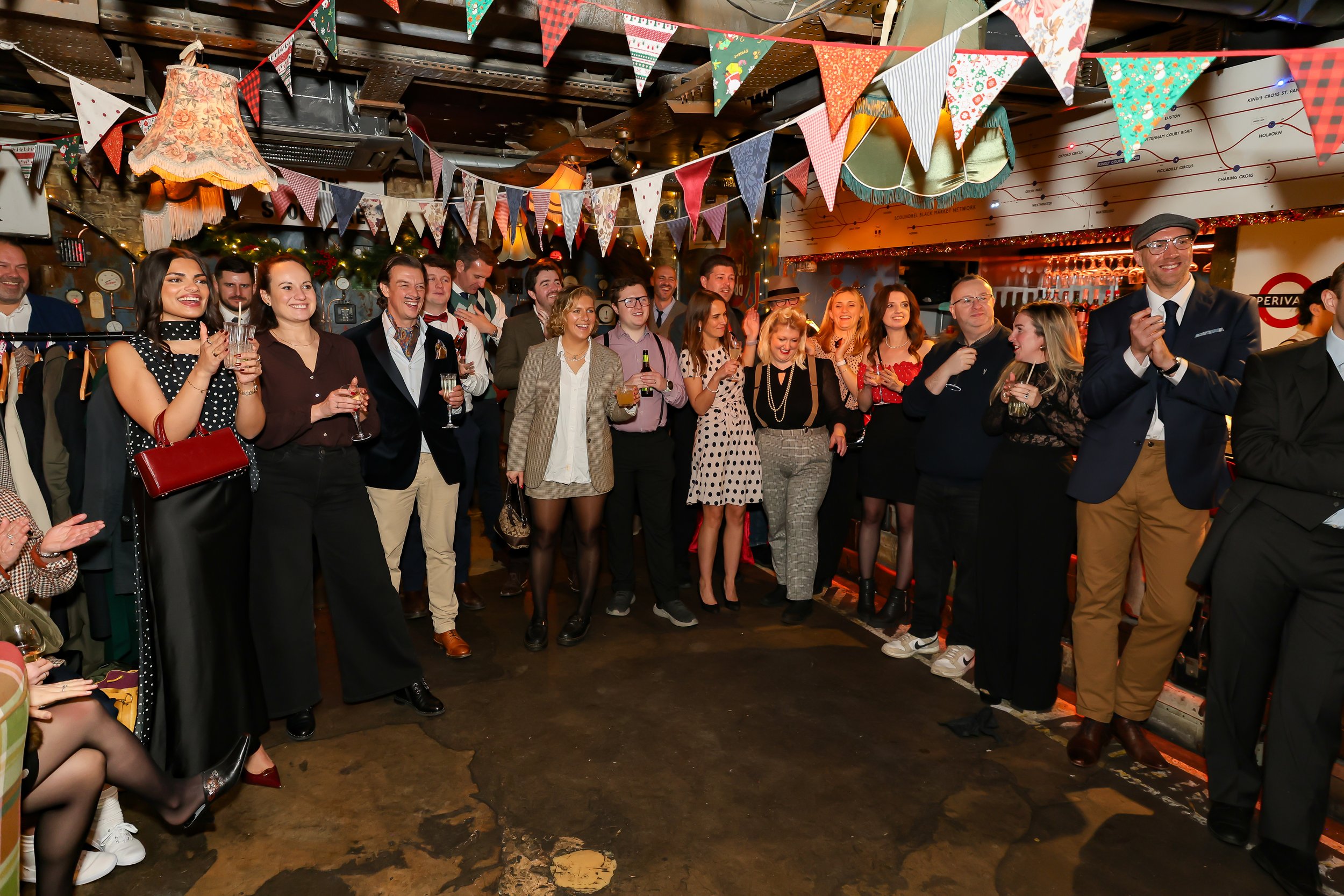 Corporate reception guests focused on a professional magic performance.