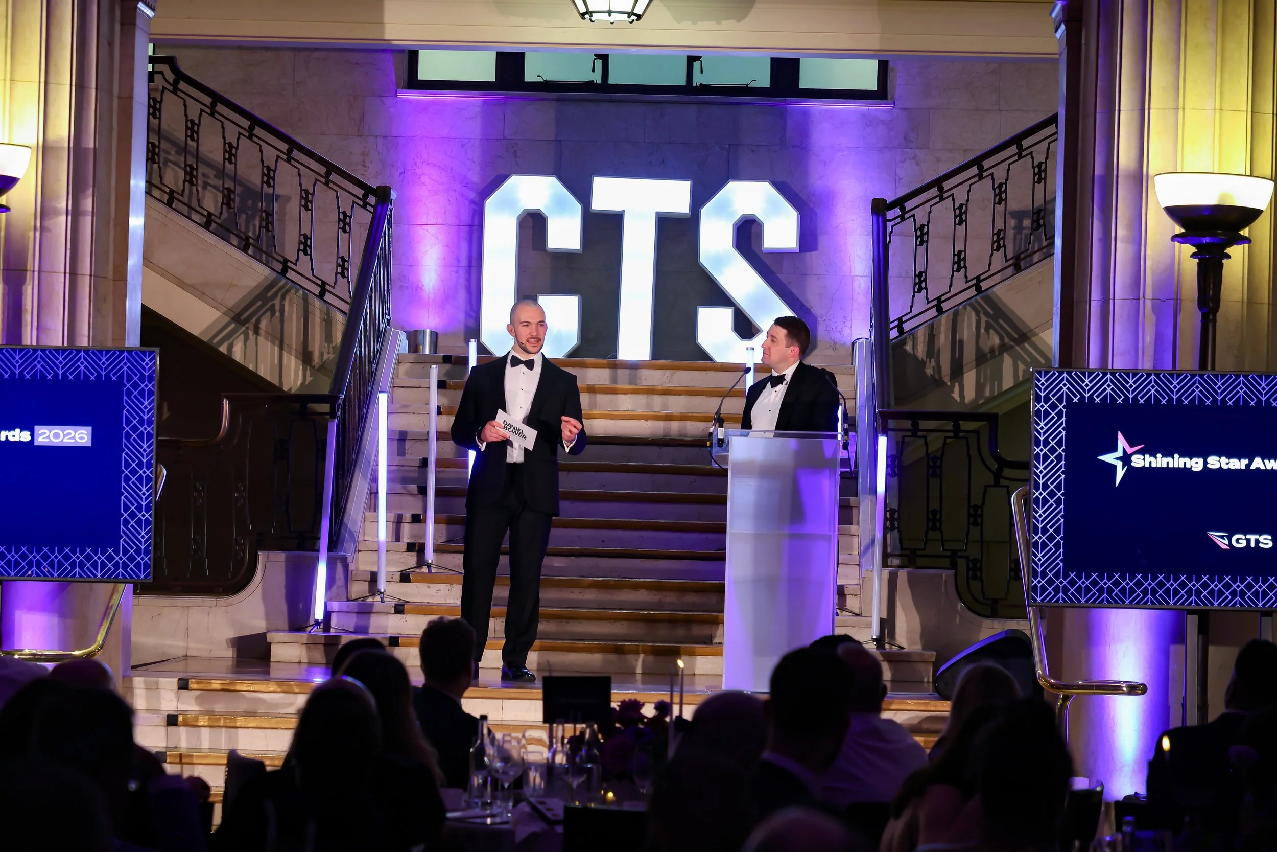 A magician engaging a guest on stage, creating a shared moment of wonder for the audience.