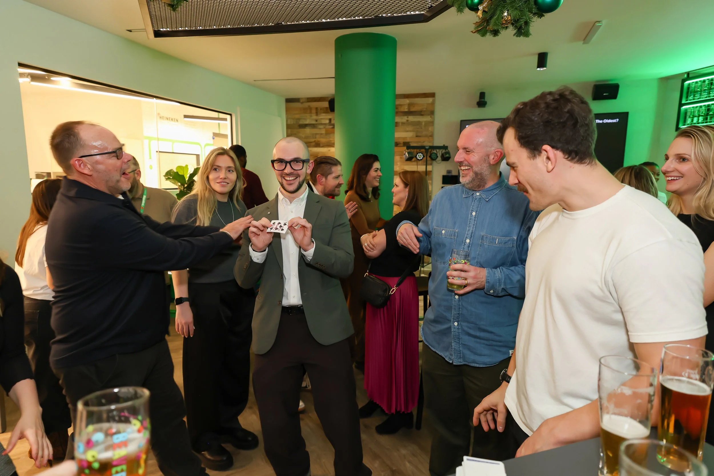 Close-up walk-around magic adds energy to a corporate reception setting.