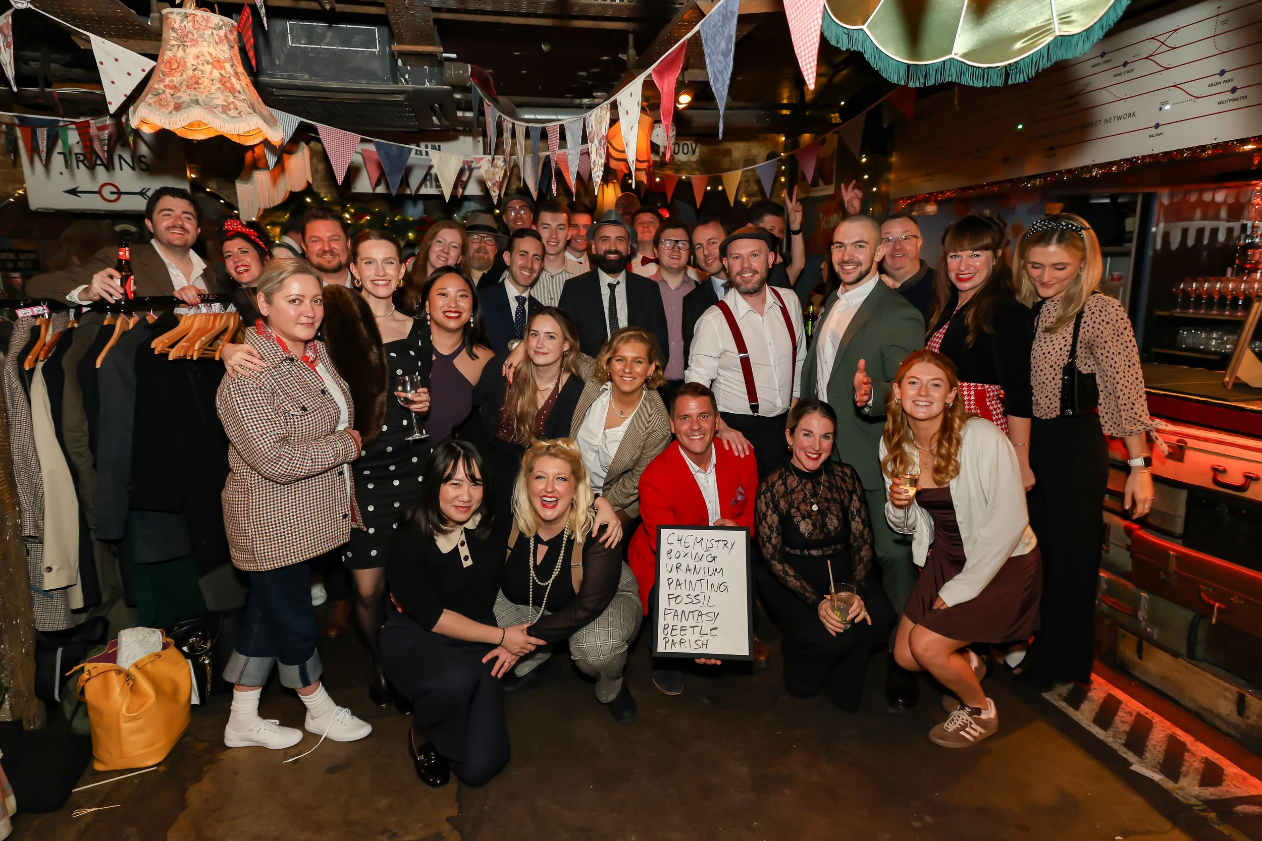 London magician standing with corporate team at a company event.