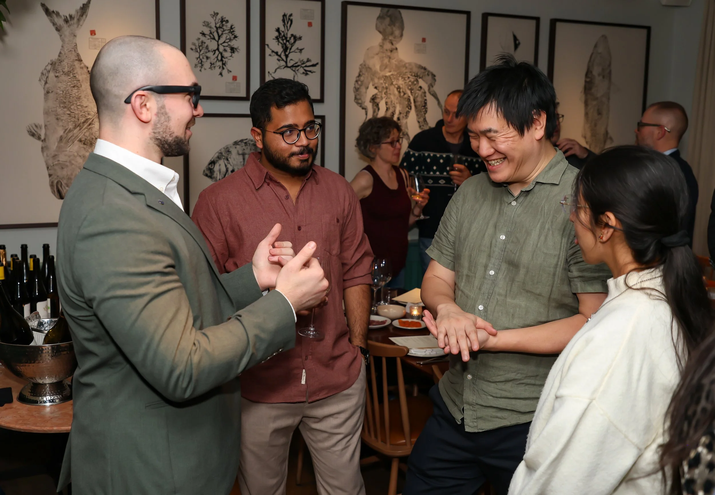 Audience reactions of surprise at a London-based corporate magic performance.