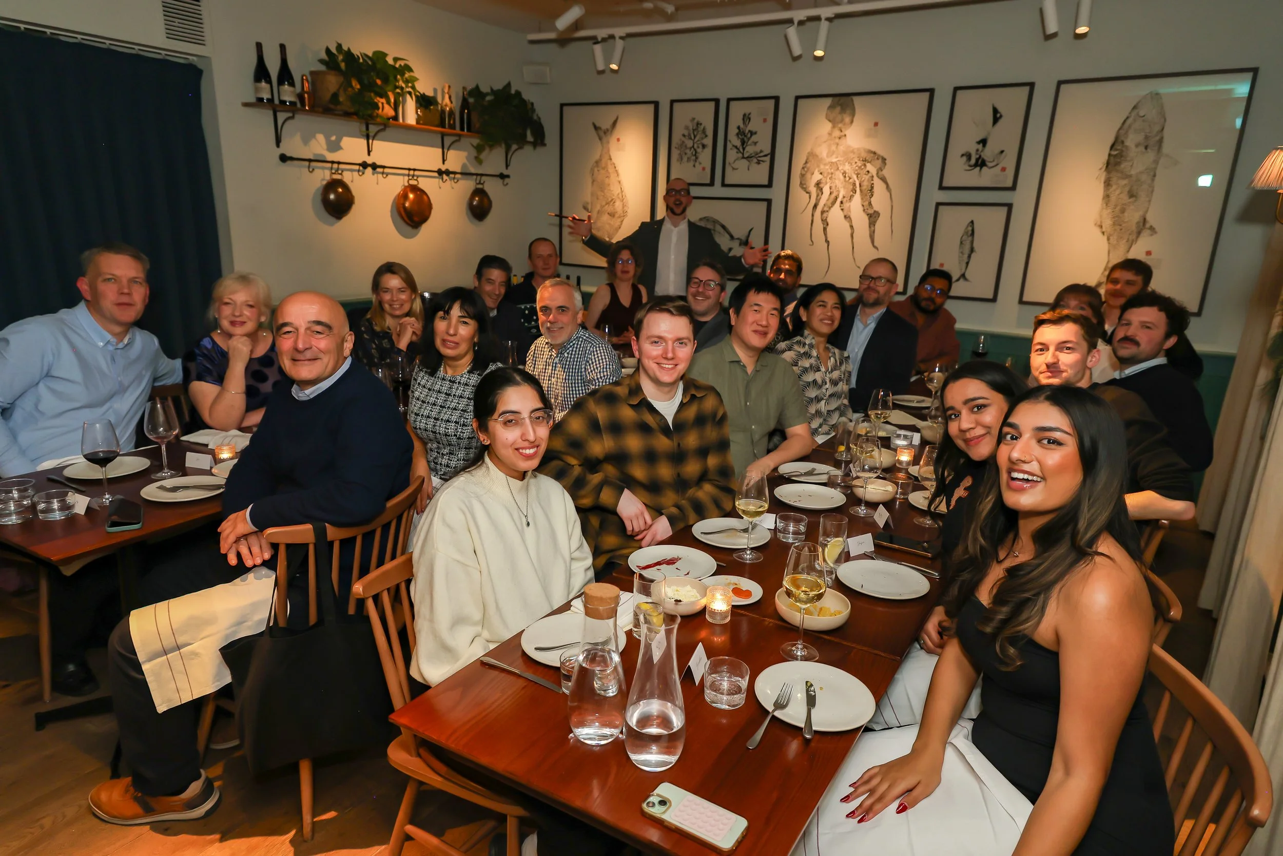 Corporate magician with the guests during dinner reception.
