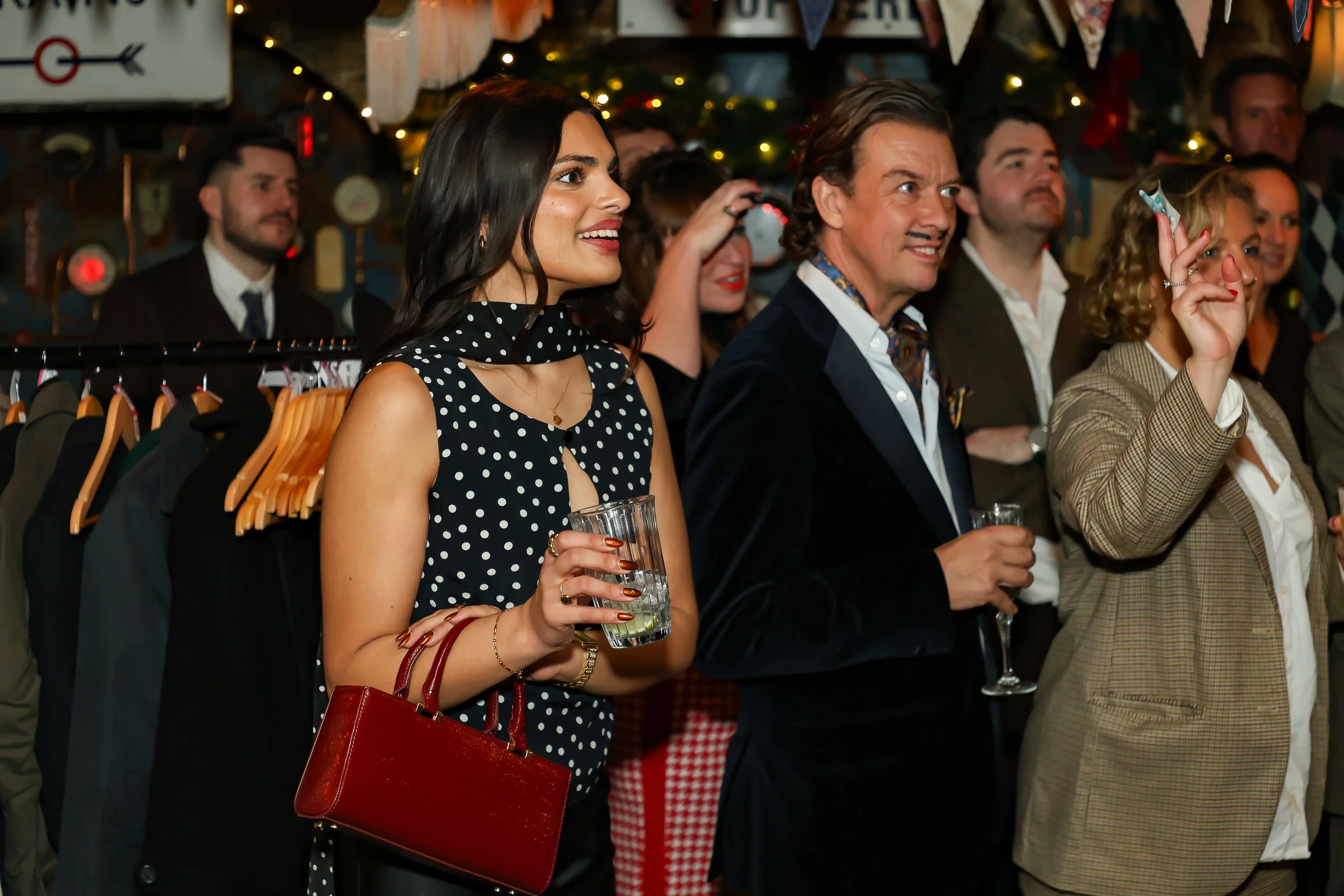 Magician performing walk-around magic for guests at reception.