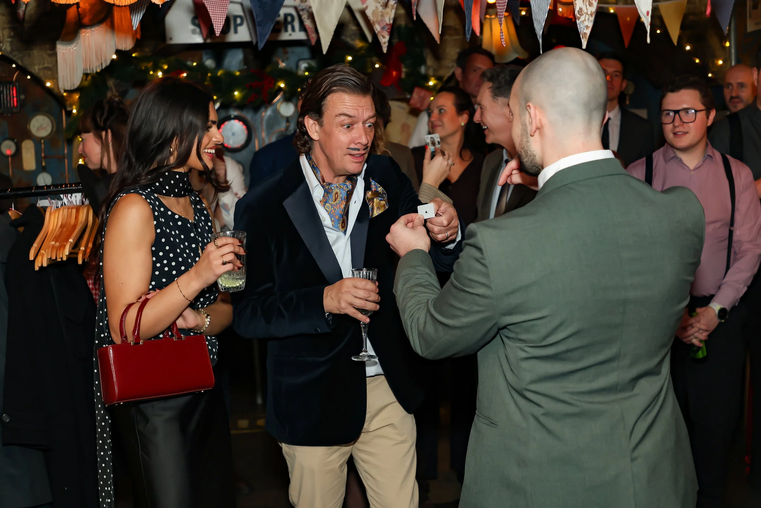 Guests gathered to watch a live magic performance during the corporate reception.