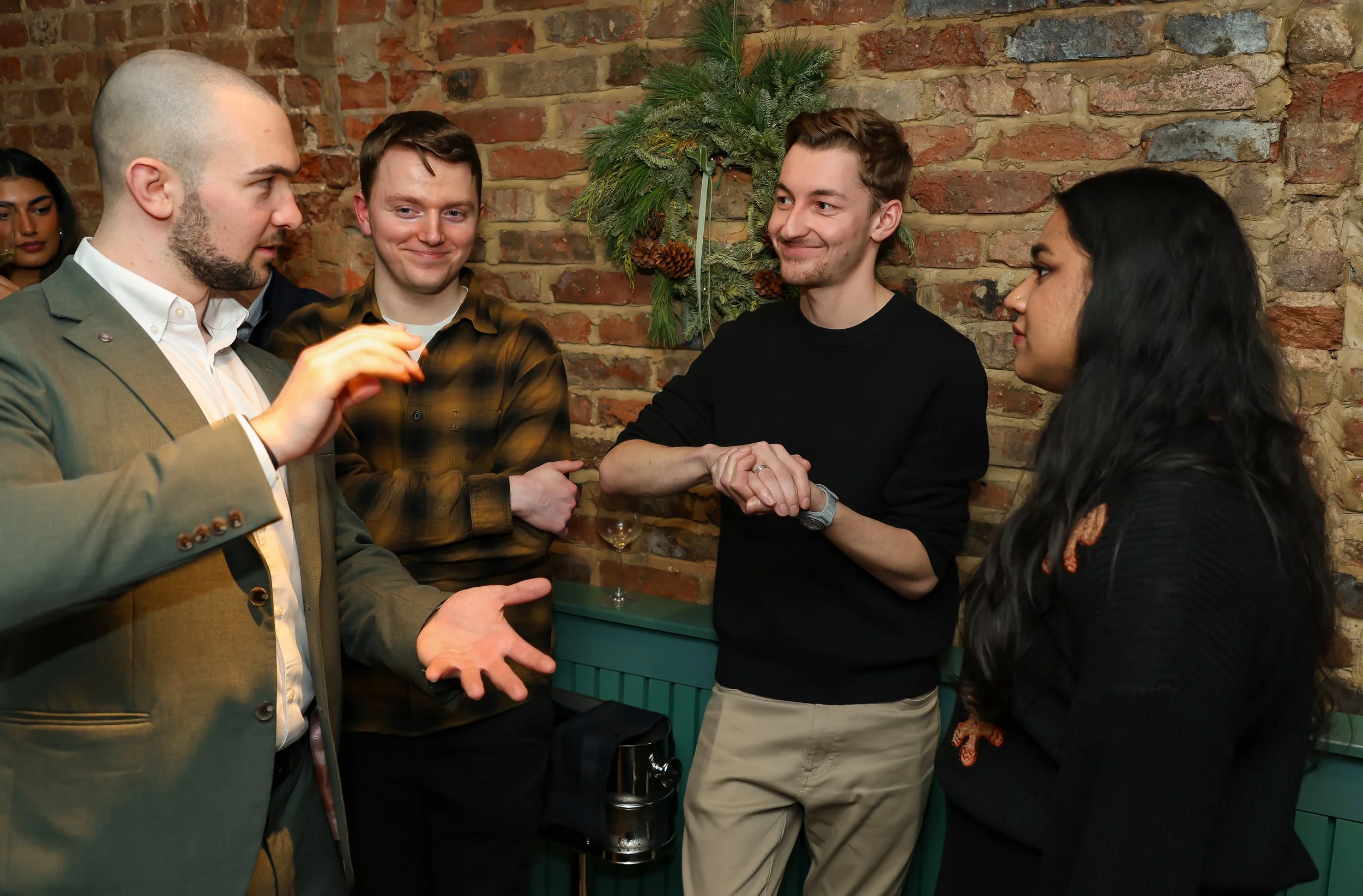 Guests participating in live illusion magic during a corporate reception.
