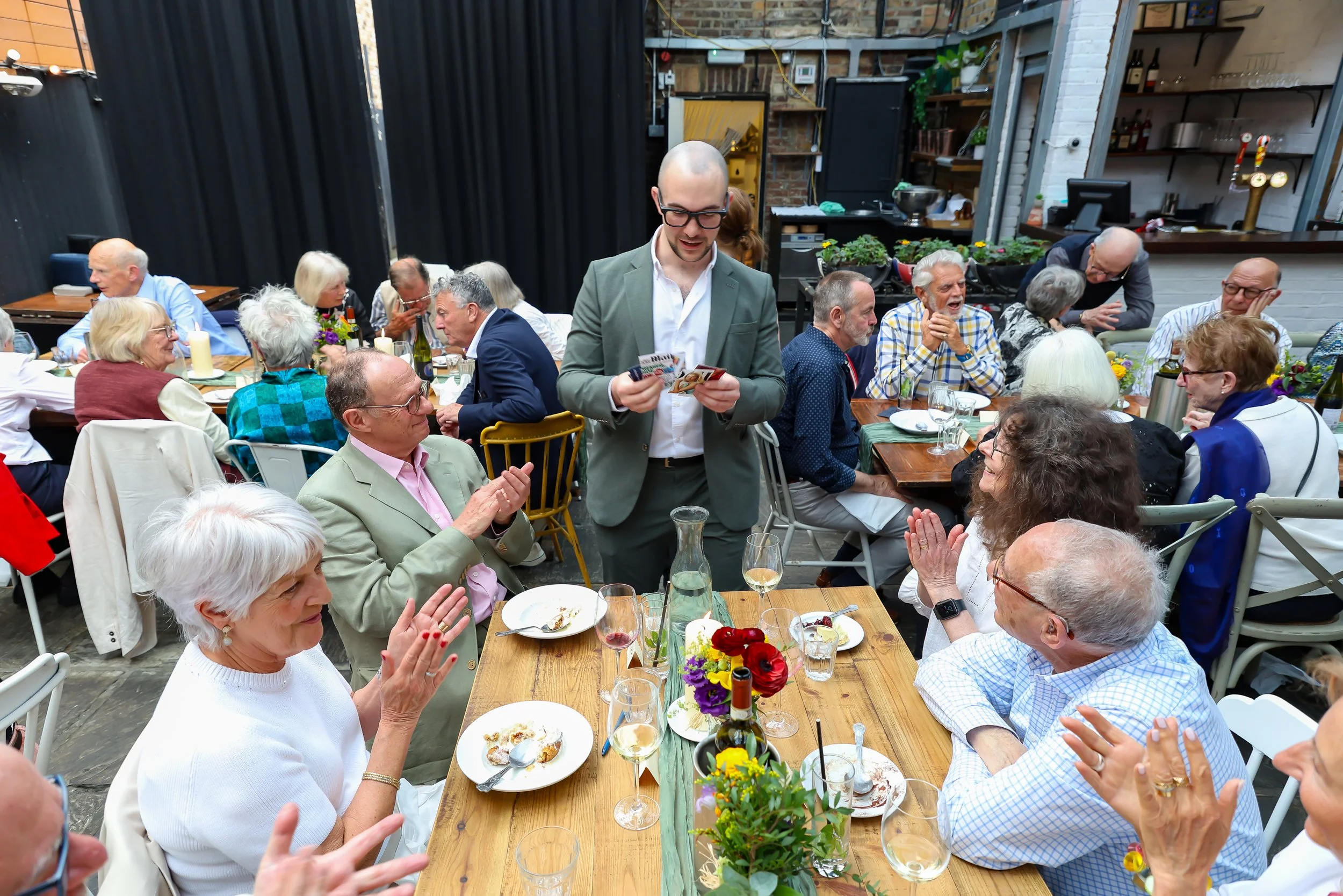 Guests applauded with the Magician card tricks. 2026-May 3 Rhoda & Baruch Golden Anniversary. 